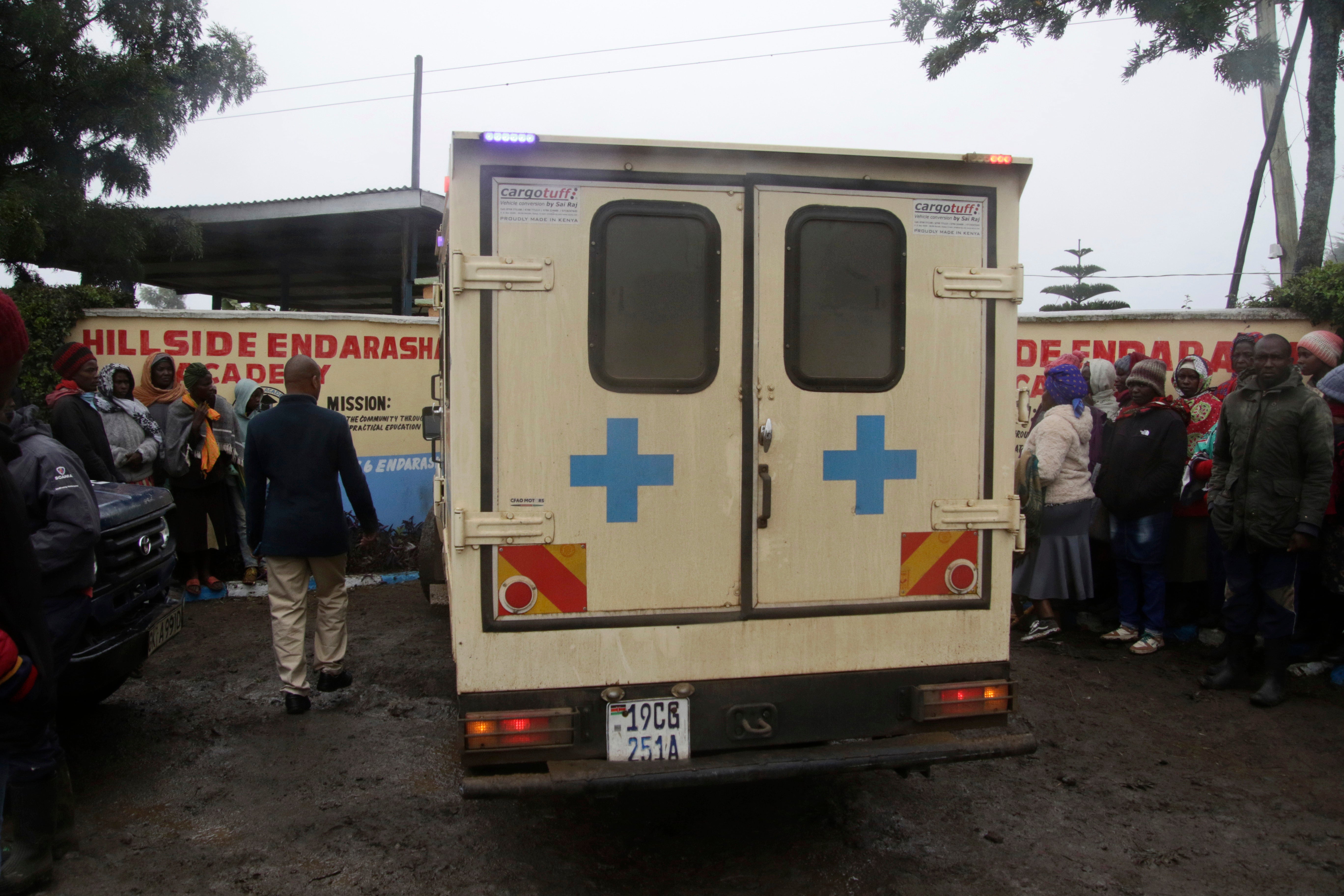 An ambulance drives inside the Hillside Endarasha Primary school following a fire incident in Nyeri, Kenya