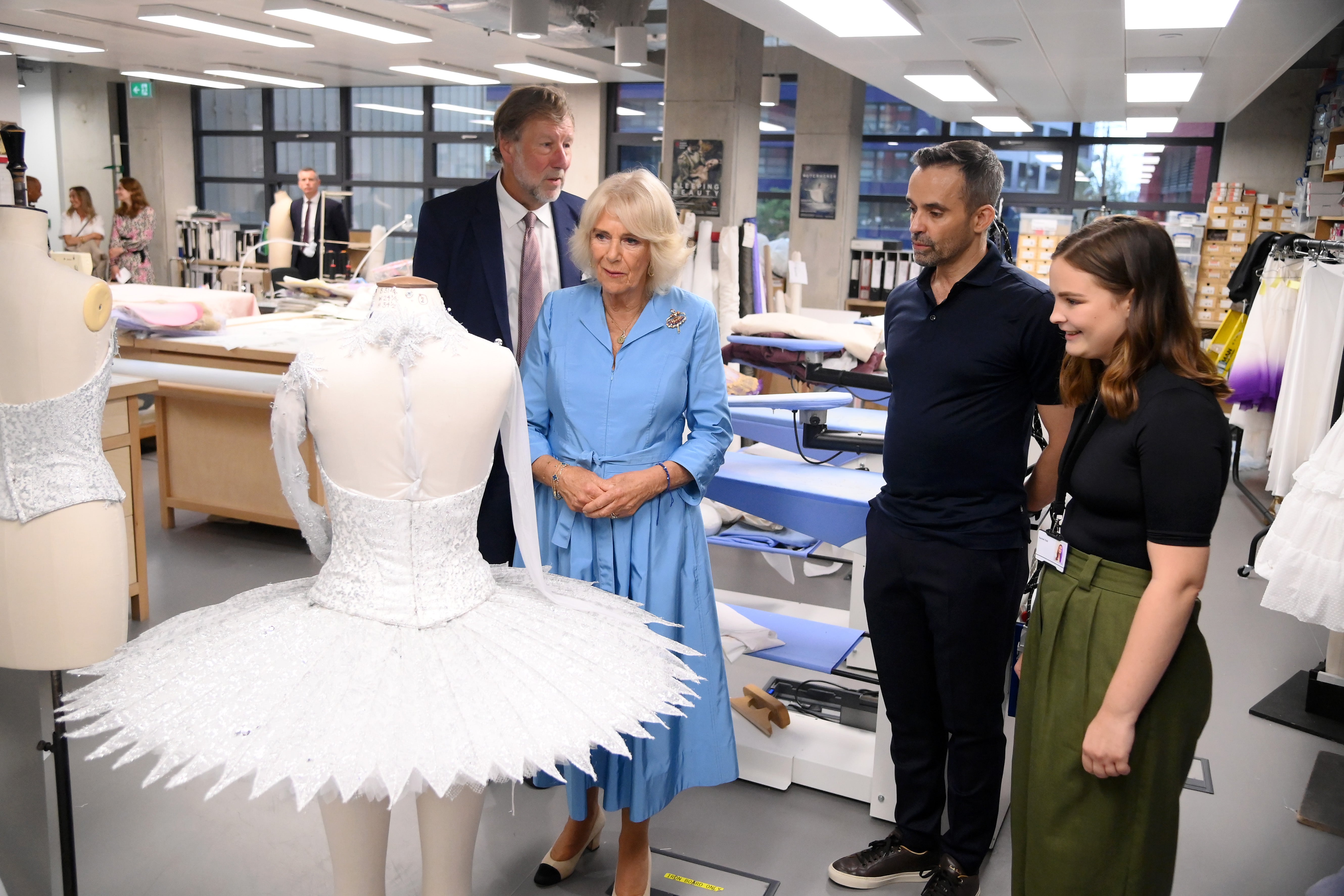 Queen Camilla, Patron of English National Ballet meets a member of staff in the Costume Atelier during a visit to the English National Ballet's Mulryan Centre for Dance in east London.