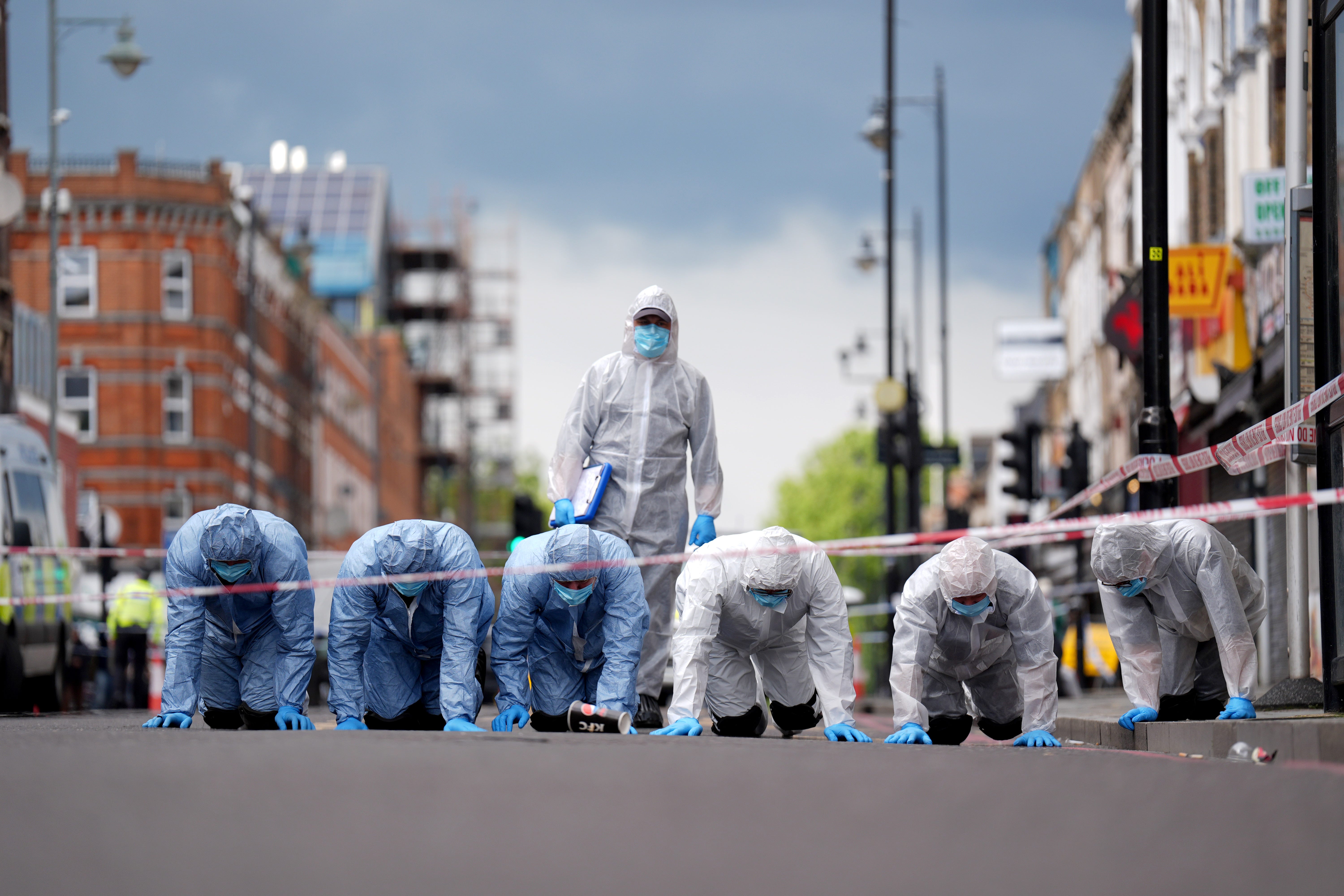 Police forensic officers on Kingsland High Street in Hackney, east London, near to the scene of the shooting (James Manning/PA)