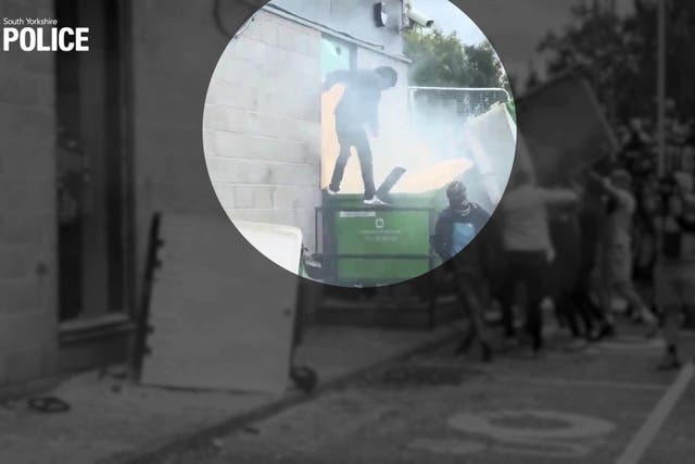 <p>A still from video footage shows painter and decorator Thomas Birley rioting outside the Holiday Inn Express, at Manvers, Rotherham, on 4 August</p>