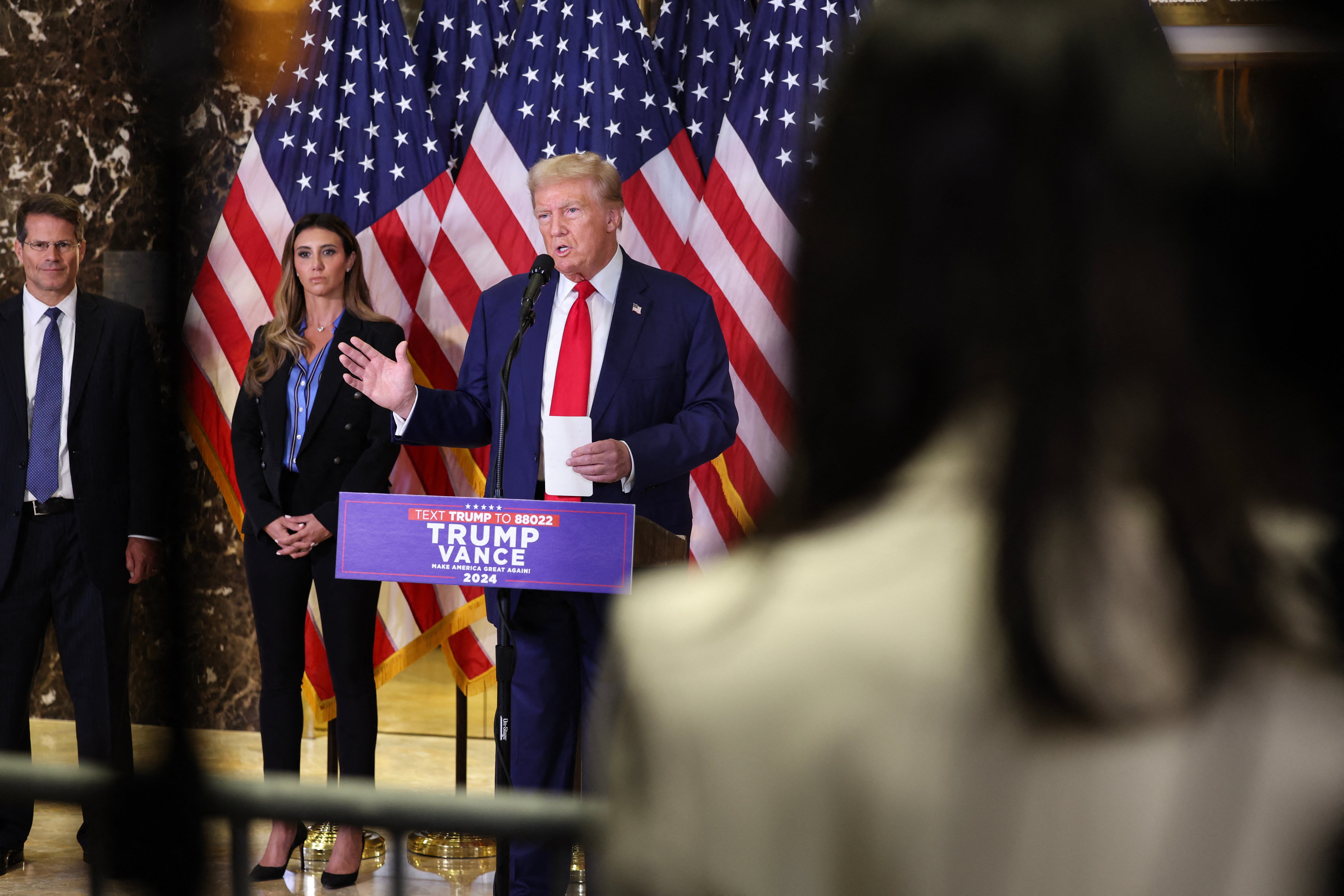 Alina Habba stands with Donald Trump at a press conference