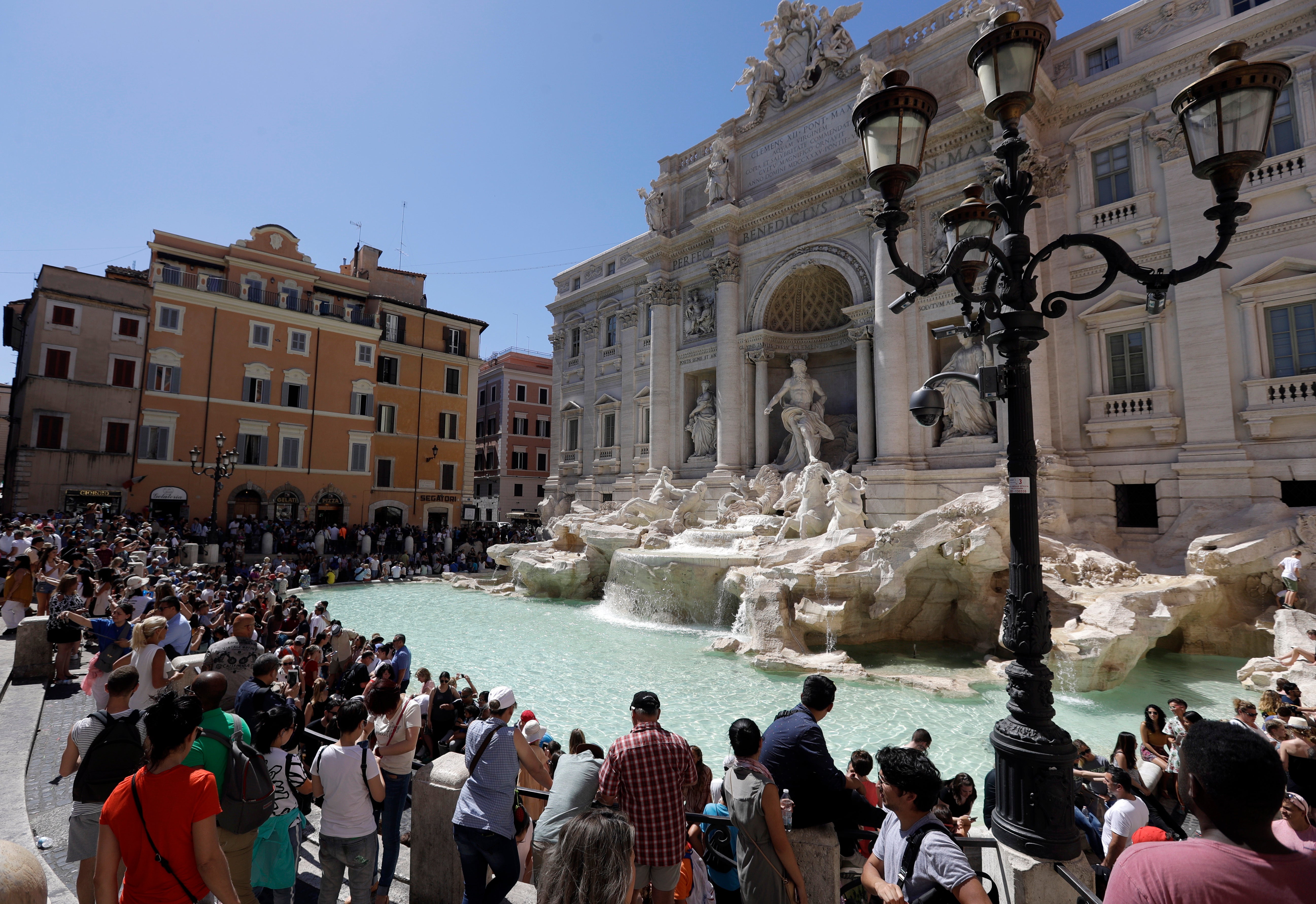 Tourists admire the Trevi Fountain in Rome