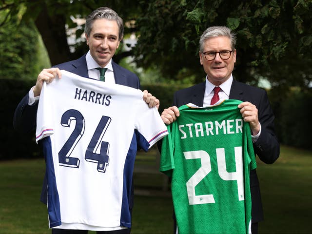 <p>Taoiseach Simon Harris (left) and prime minister Sir Keir Starmer, hold up England and Ireland football shirts at Farmleigh House, Dublin</p>