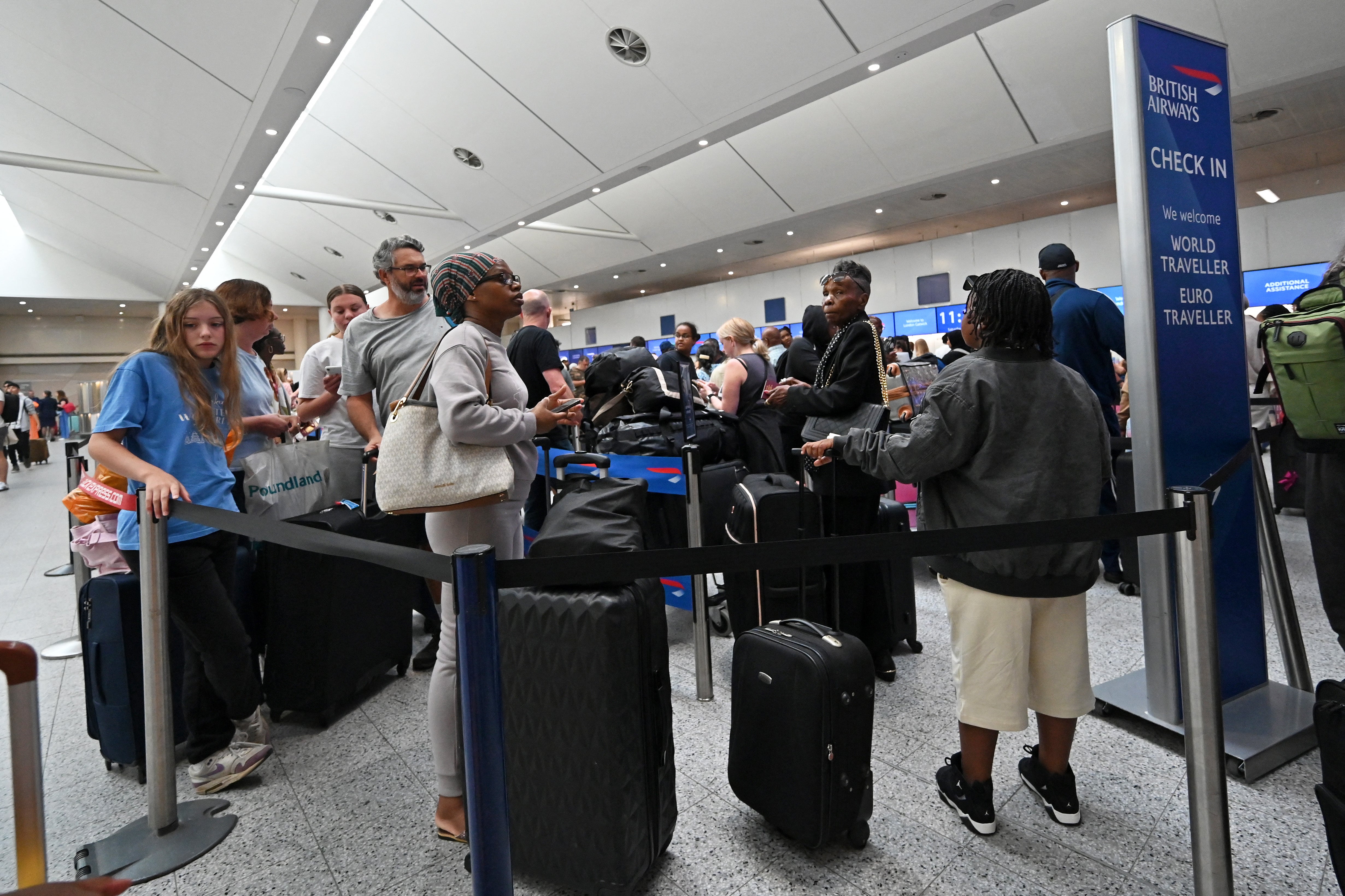 Passengers queue at Gatwick on 20 July