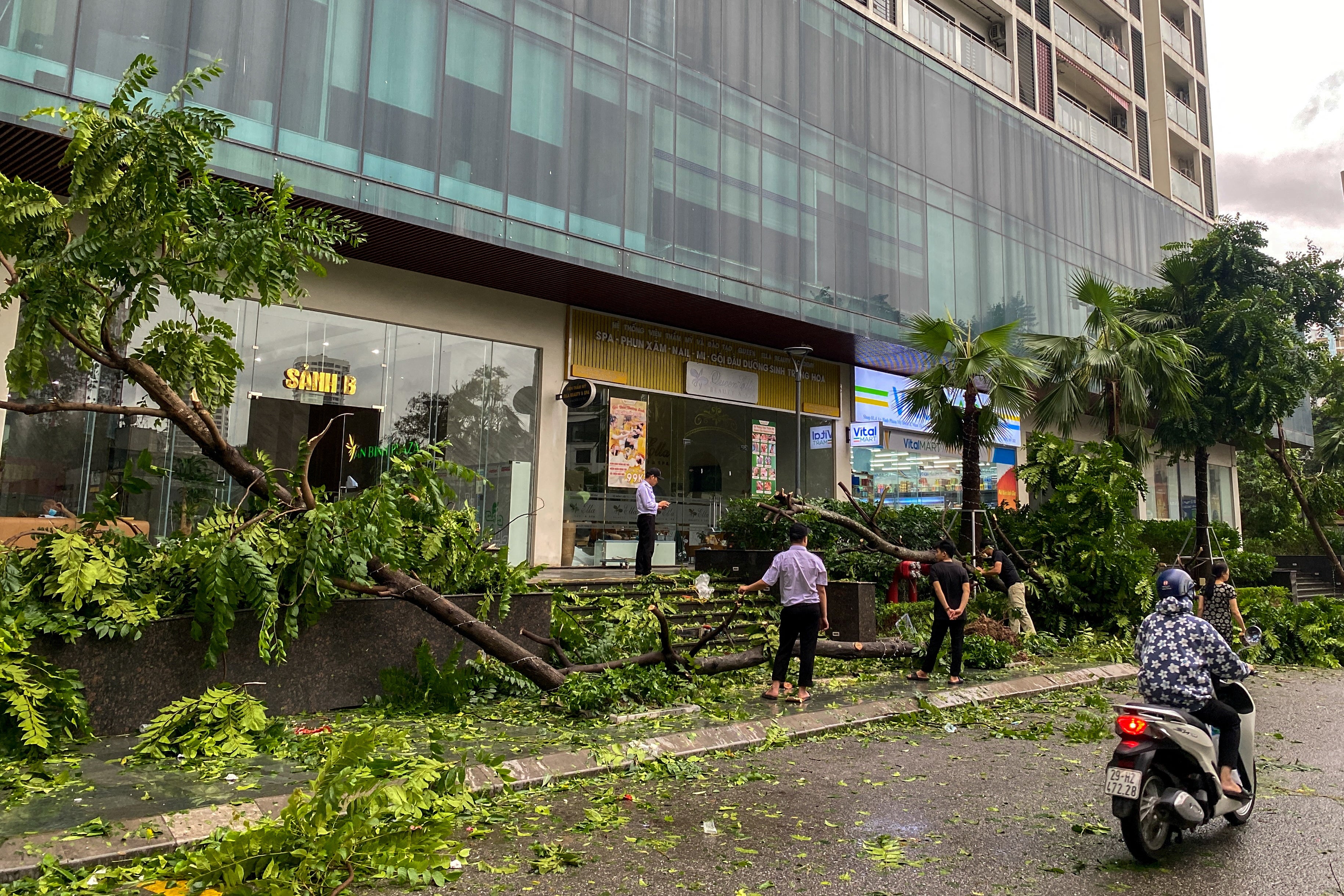 People stand near a devastated area following the impact of Typhoon Yagi, in Hanoi, Vietnam, September 8, 2024