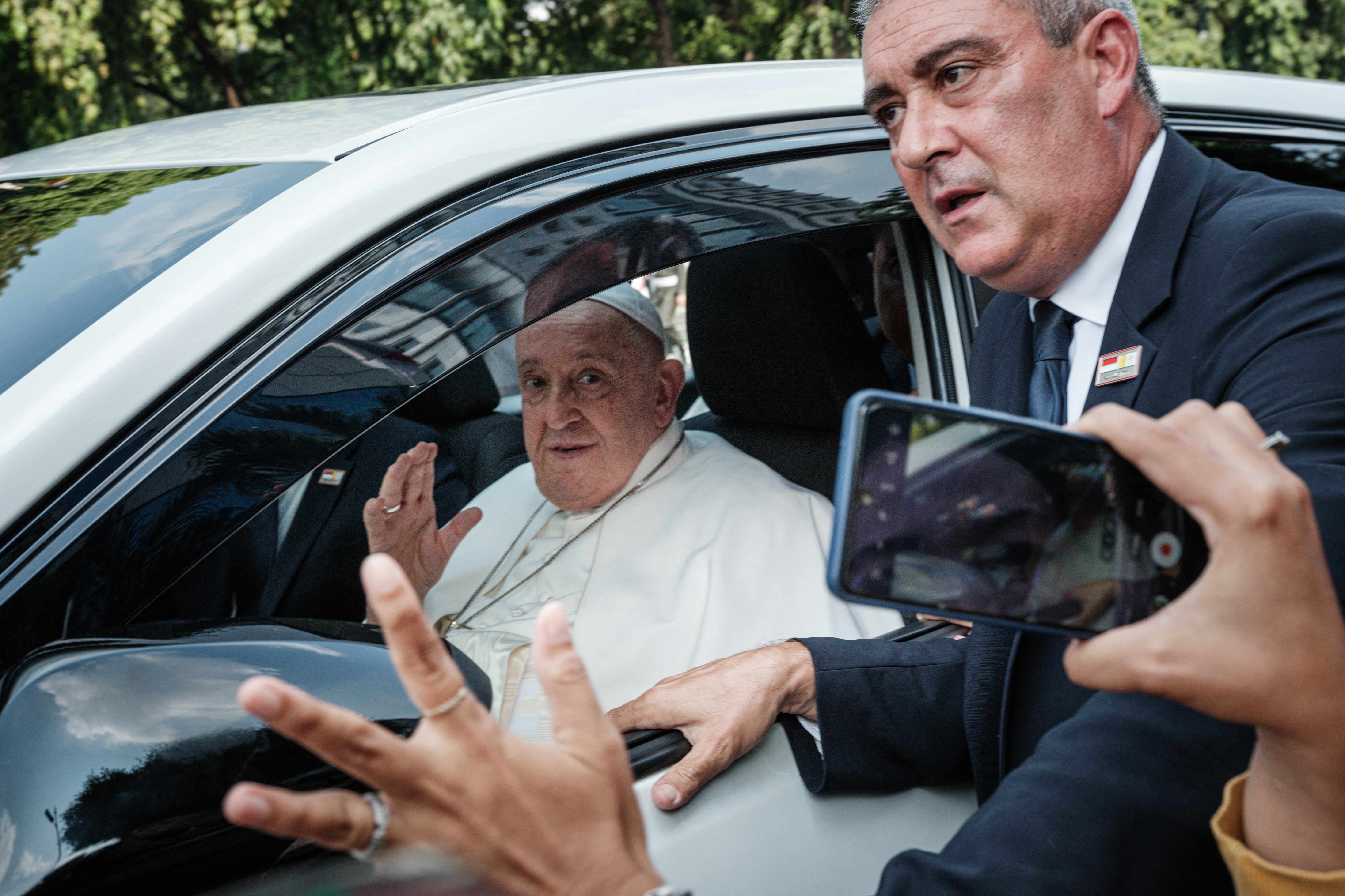 Pope Francis reacts as he leaves Vatican’s diplomatic mission in Jakarta for the Soekarno-Hatta International Airport ahead of his departure to Papua New Guinea