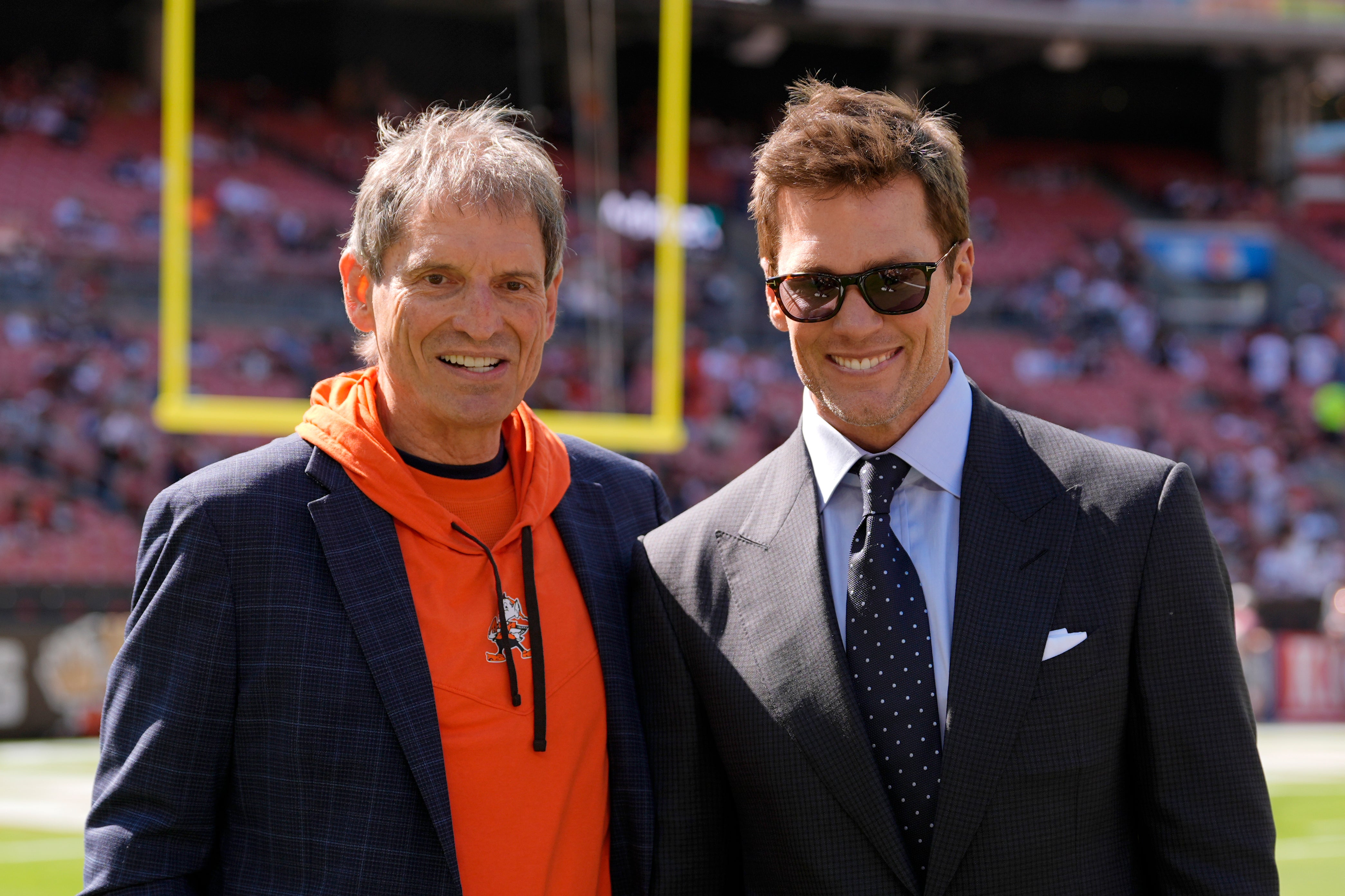 <p>Bernie Kosar pictured alongside NFL legend Tom Brady</p>