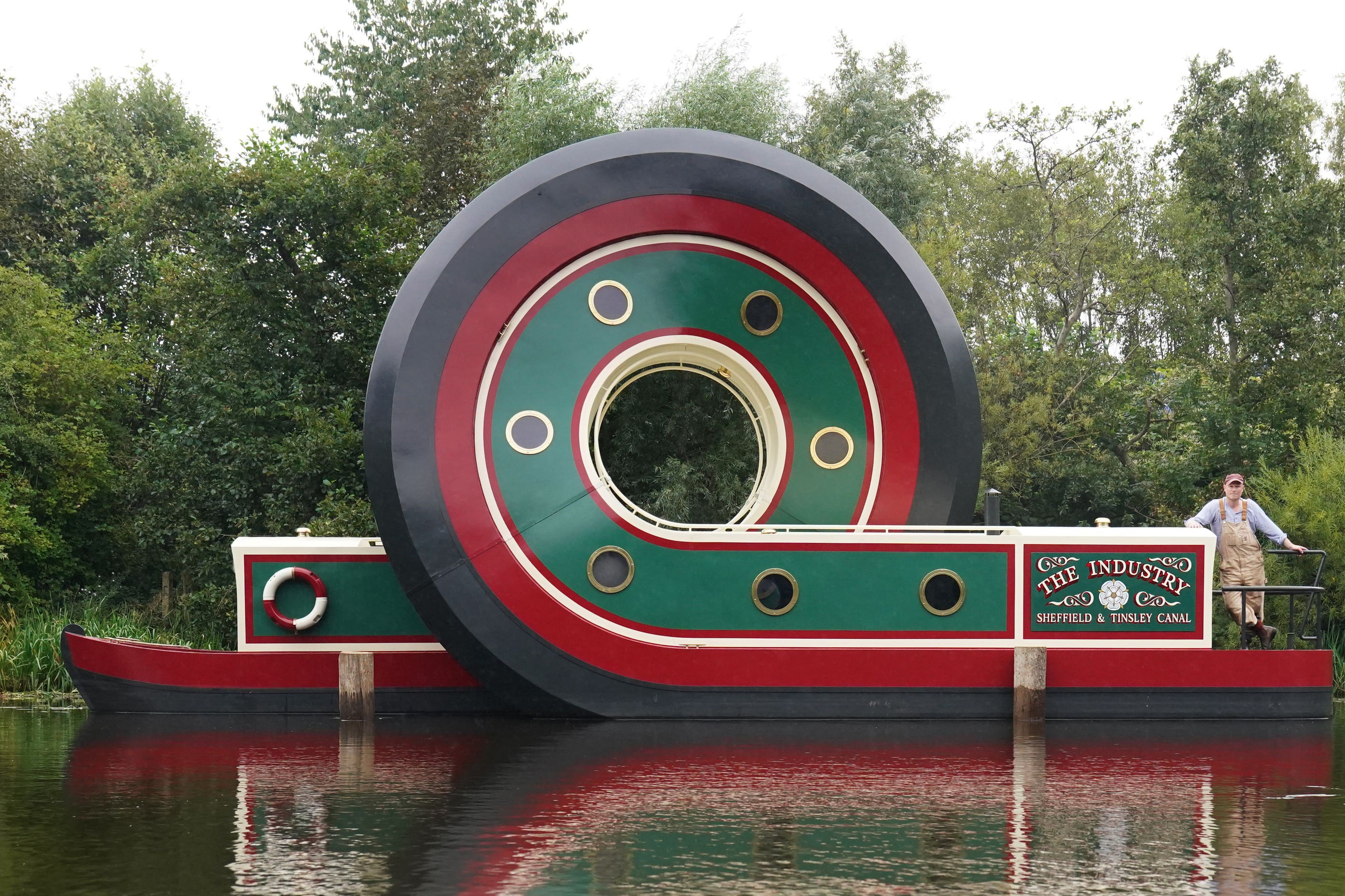 Artist Alex Chinneck with his sculpture of a canal boat (Owen Humphreys/PA)