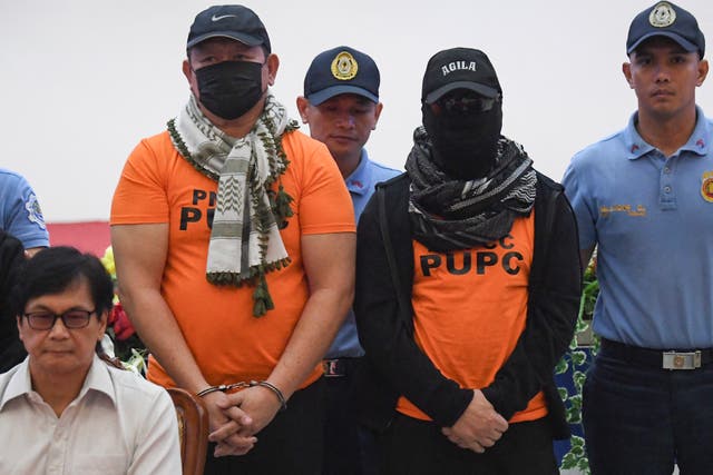 <p>Apollo Quiboloy (3rd R), Philippine pastor and founder of the Philippines-based Kingdom of Jesus Christ (KOJC) church, and co-accused (in orange) are presented to members of the media during a press conference presided by Philippines' Secretary of Interior Benjamin Abalos Jr (L) inside the national police headquarters in Manila on 9 September 2024</p>