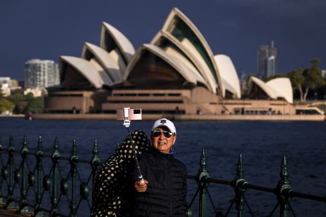 <p>File: A tourist takes a selfie in front of the Sydney Opera House</p>