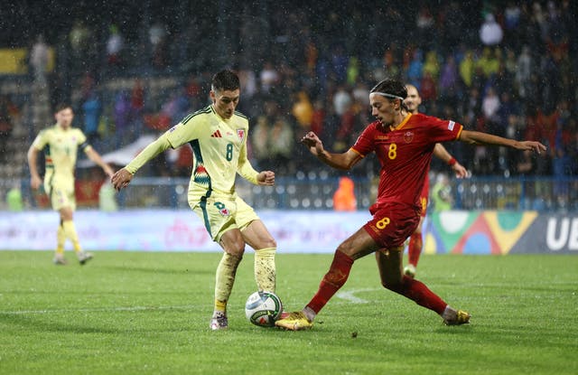 <p>Harry Wilson is challenged by Montenegro’s Milos Brnovic</p>