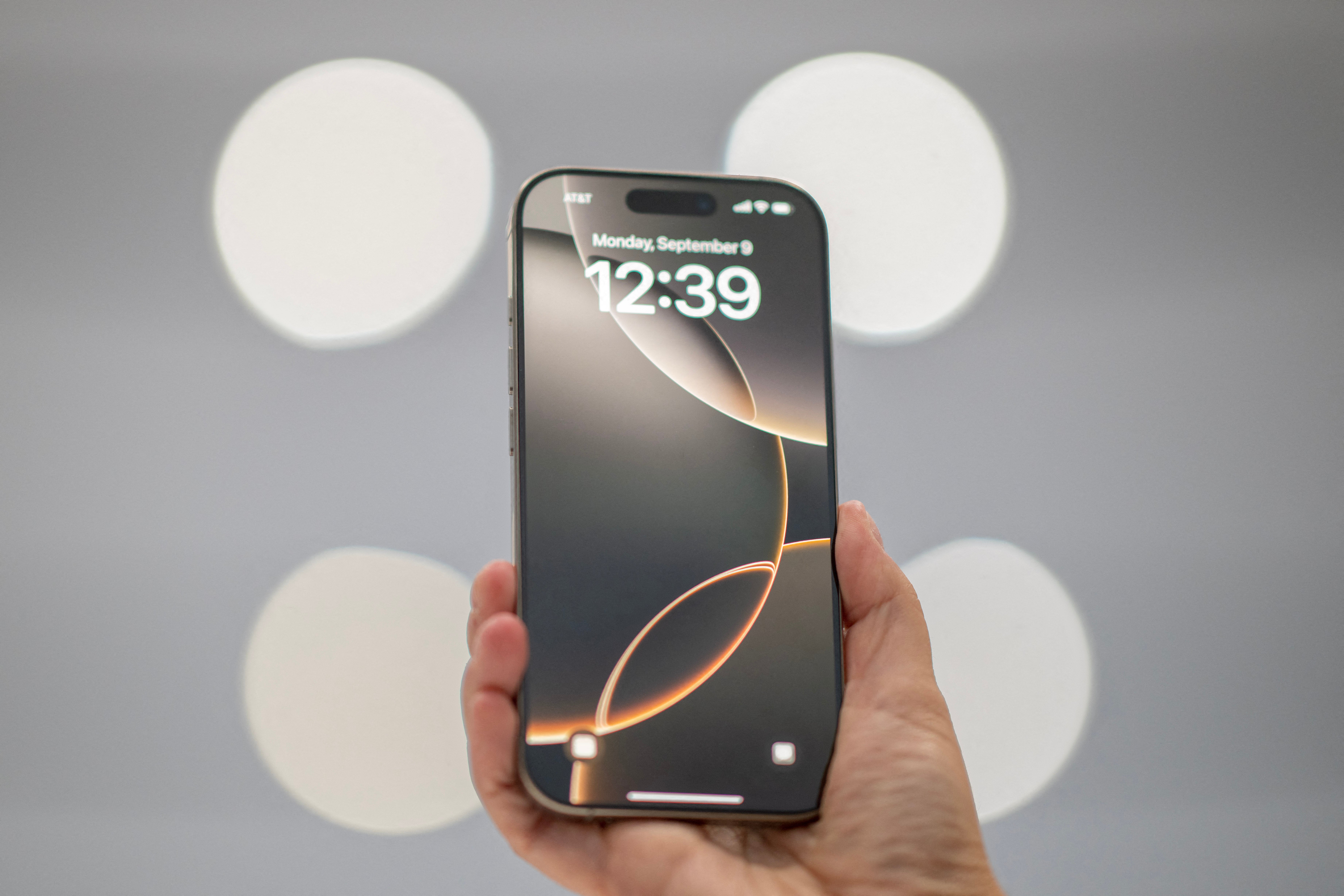 A specialist holds up an iPhone 16 Pro Max following Apple’s ‘It’s Glowtime’ event in Cupertino, California