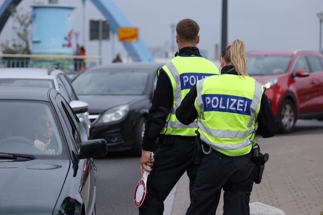 <p>File: German police monitor vehicles arriving from Poland at a temporary border checkpoint</p>