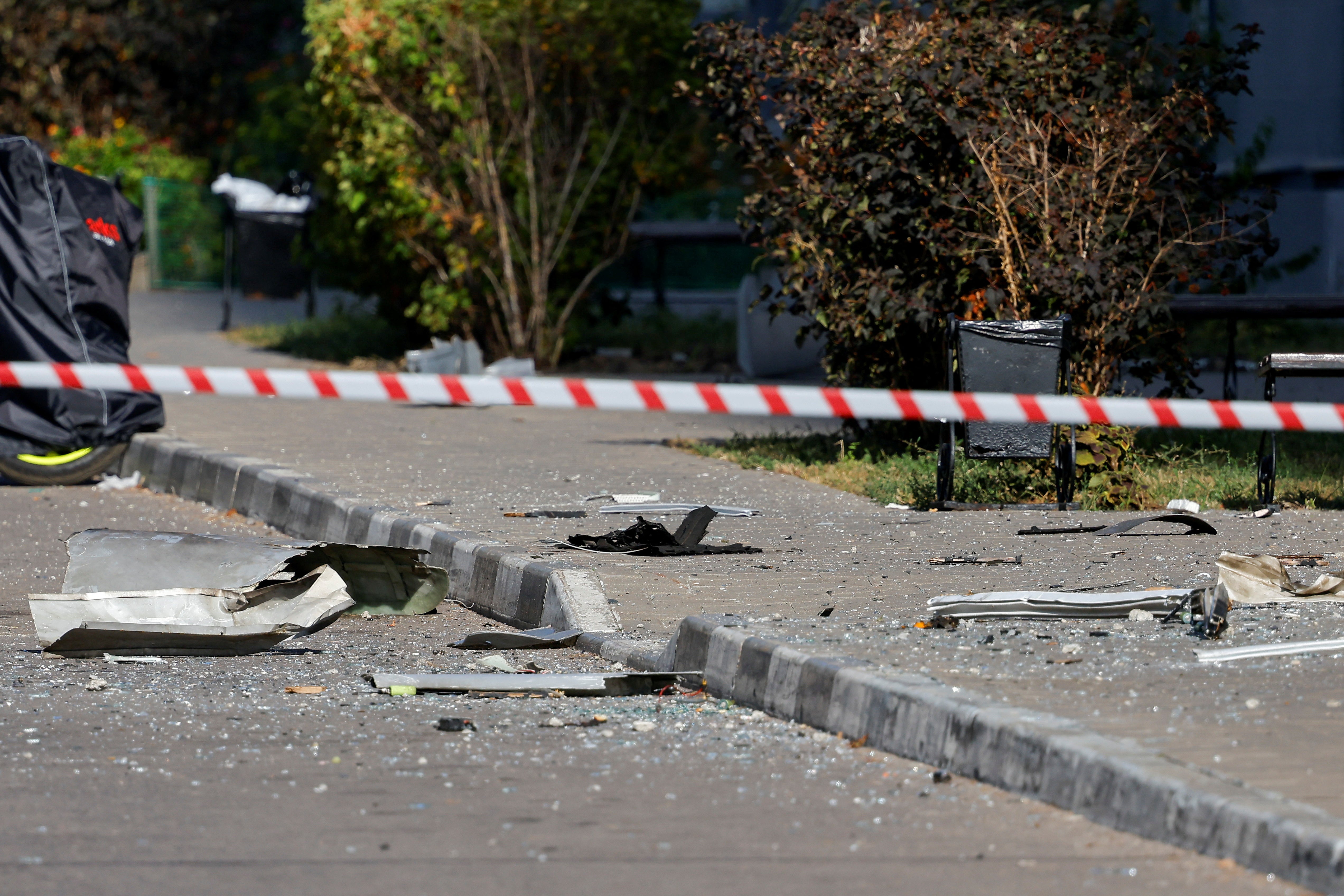 Police officers use tape to block off the area near a damaged multi-storey residential building following an alleged Ukrainian drone attack