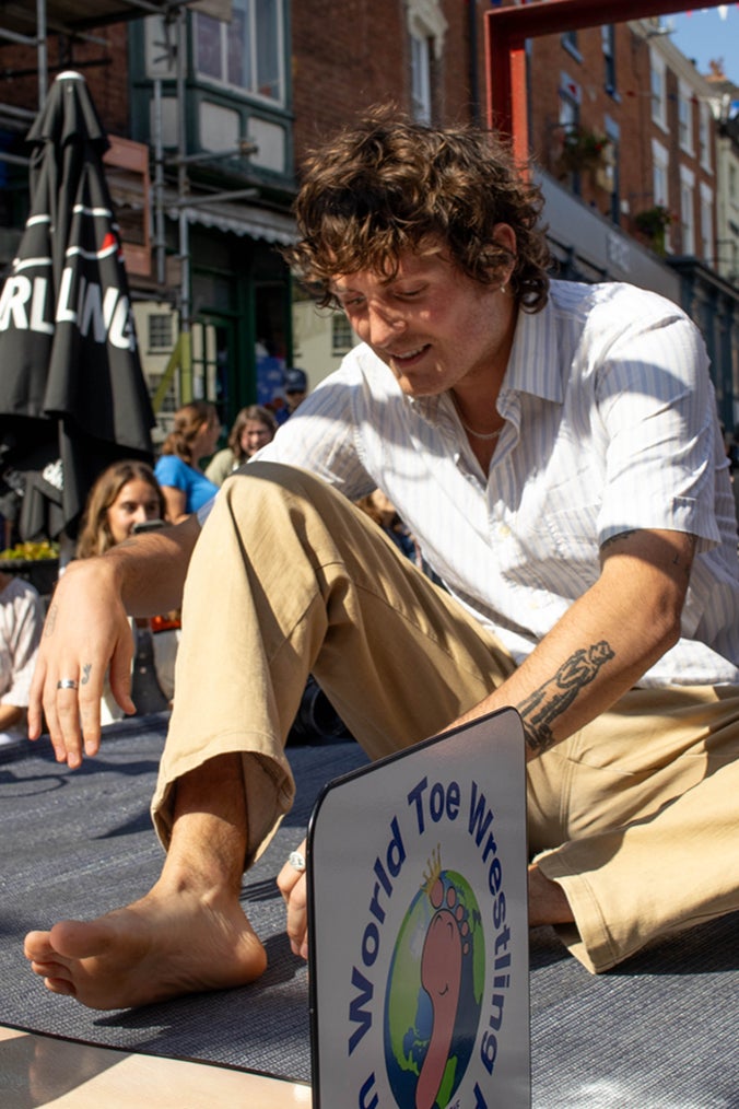 Toeing the line: A competitor prepares his feet for wrestling