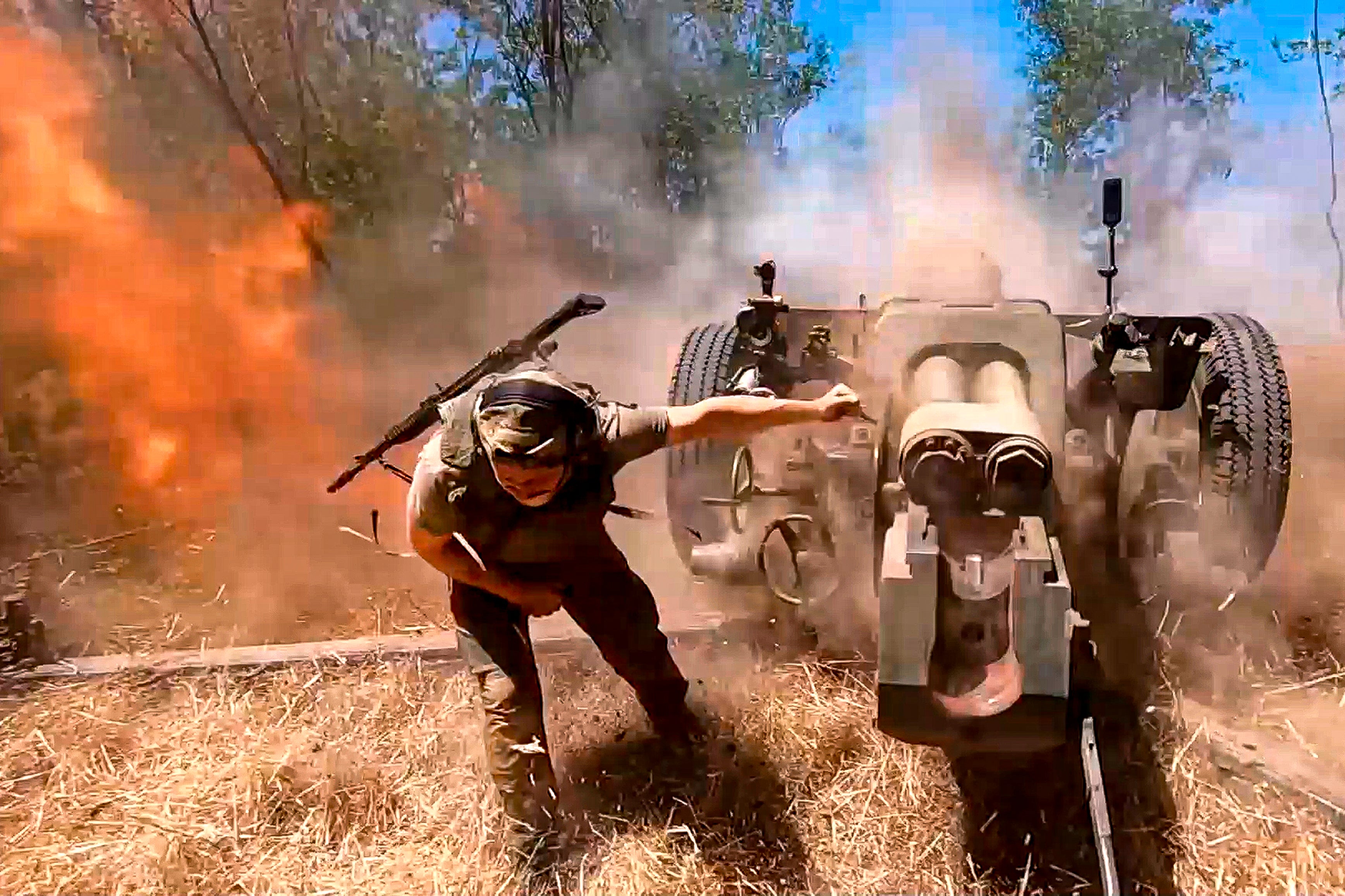 A Russian soldier fires from D-30 howitzer towards Ukrainian positions in an undisclosed location in Ukraine