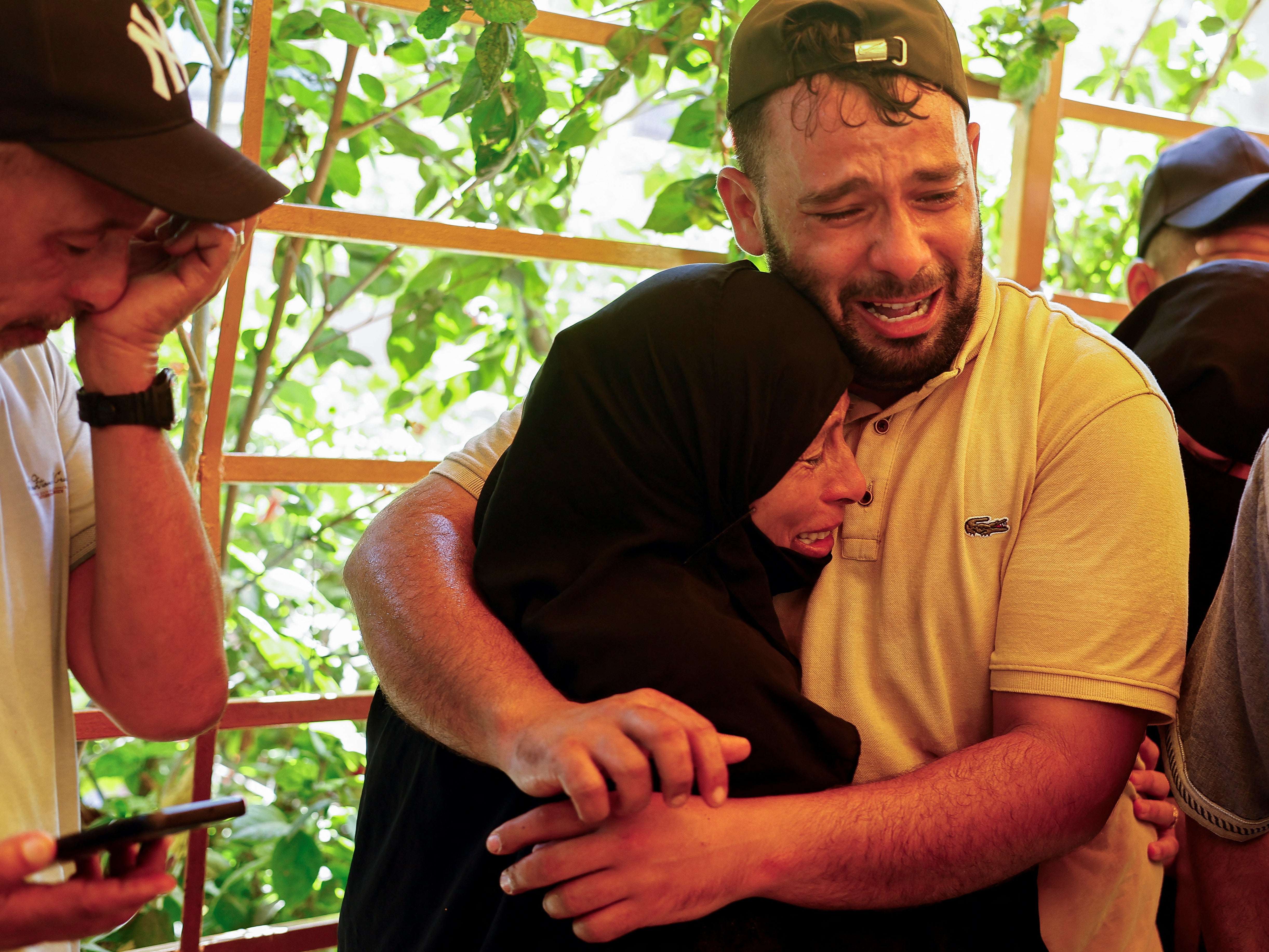 Relatives at the Nasser hospital in Khan Younis mourn victims of the Israeli strike on a tent camp