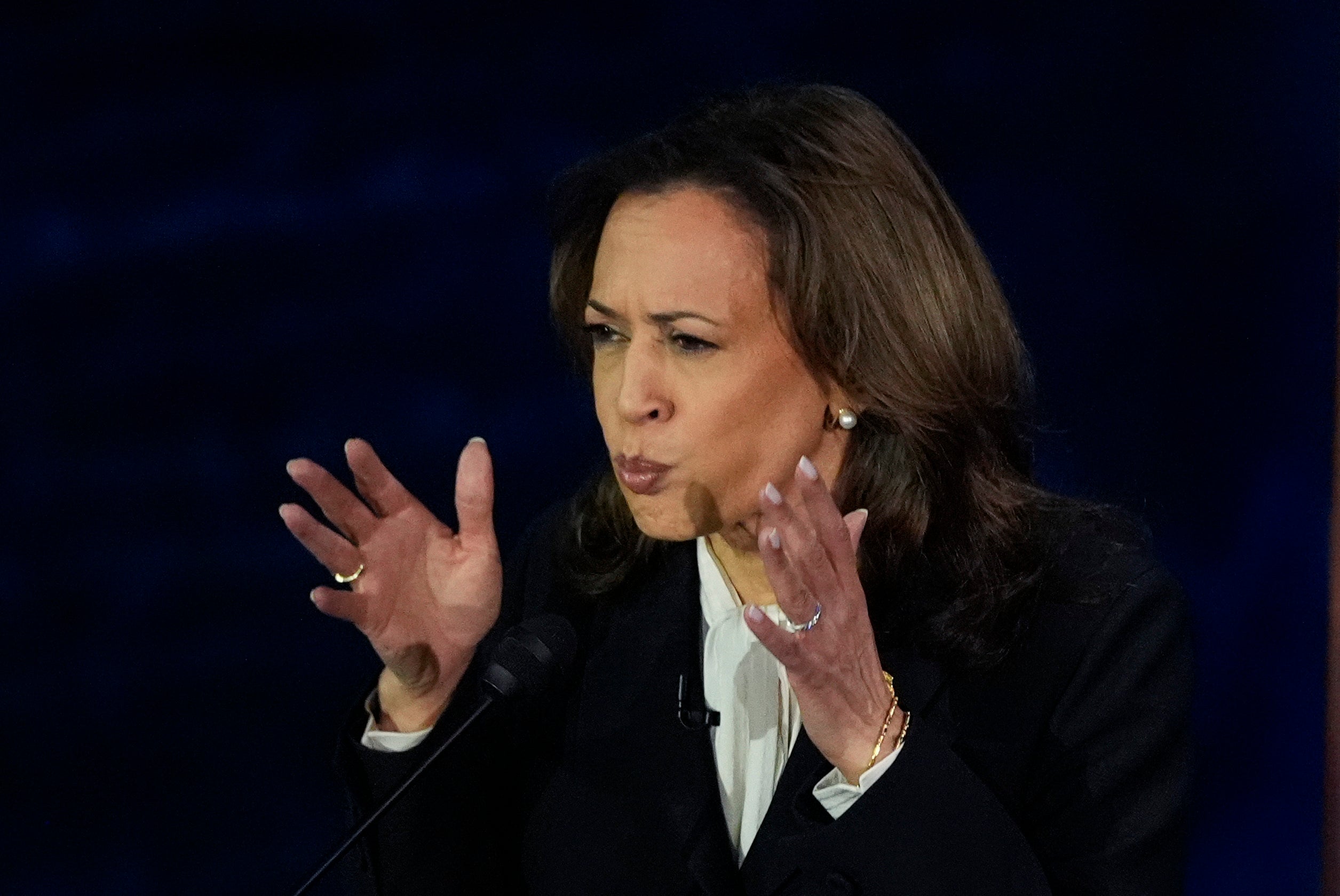 Harris listens to Trump during the debate. She threw him off his game by just bringing up his rallies.