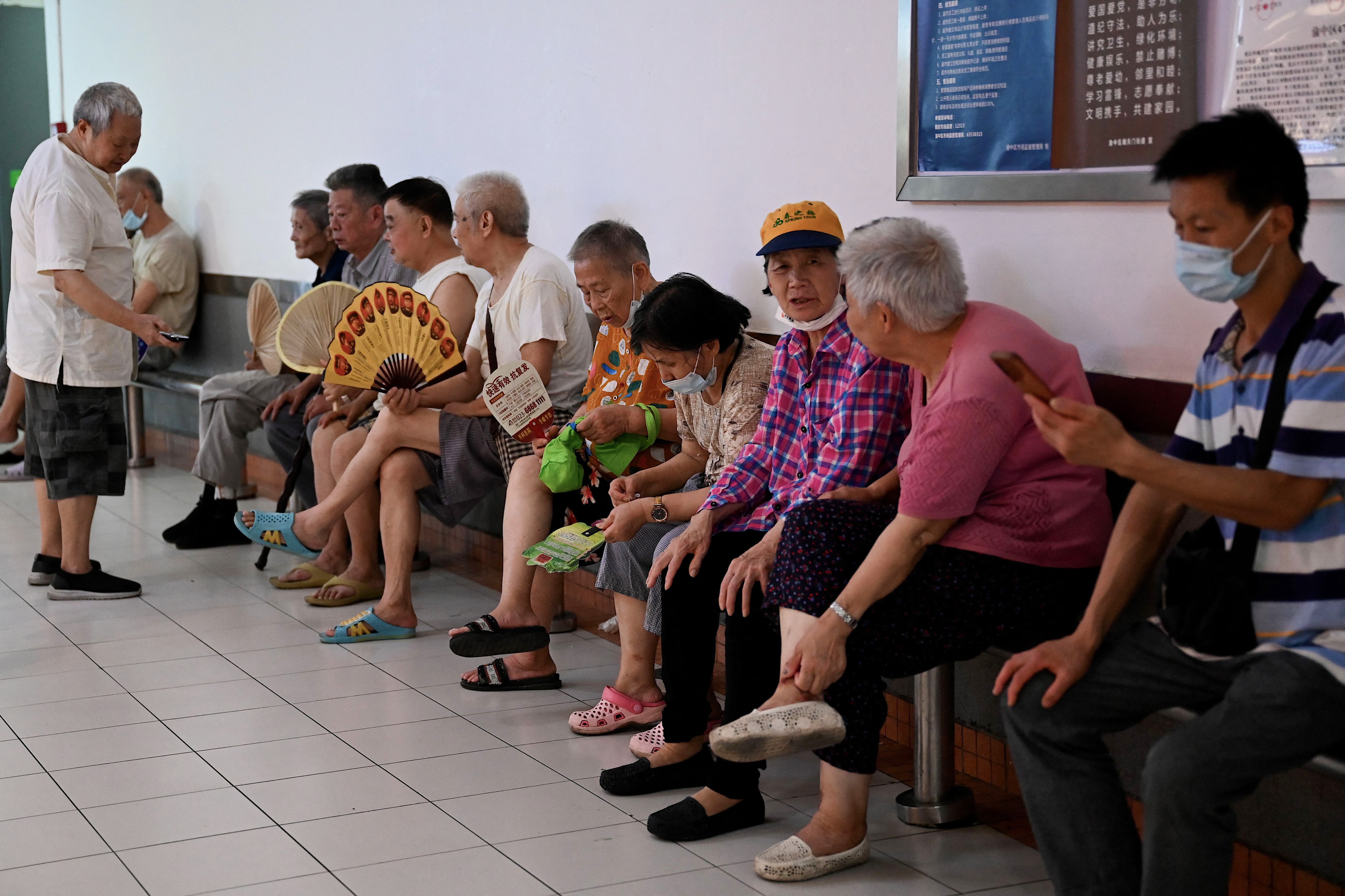 <p>Elderly people rest inside a mall as they keep cool and avoid scorching outdoor temperatures in China's southwestern city of Chongqing on 24 August 2022</p>