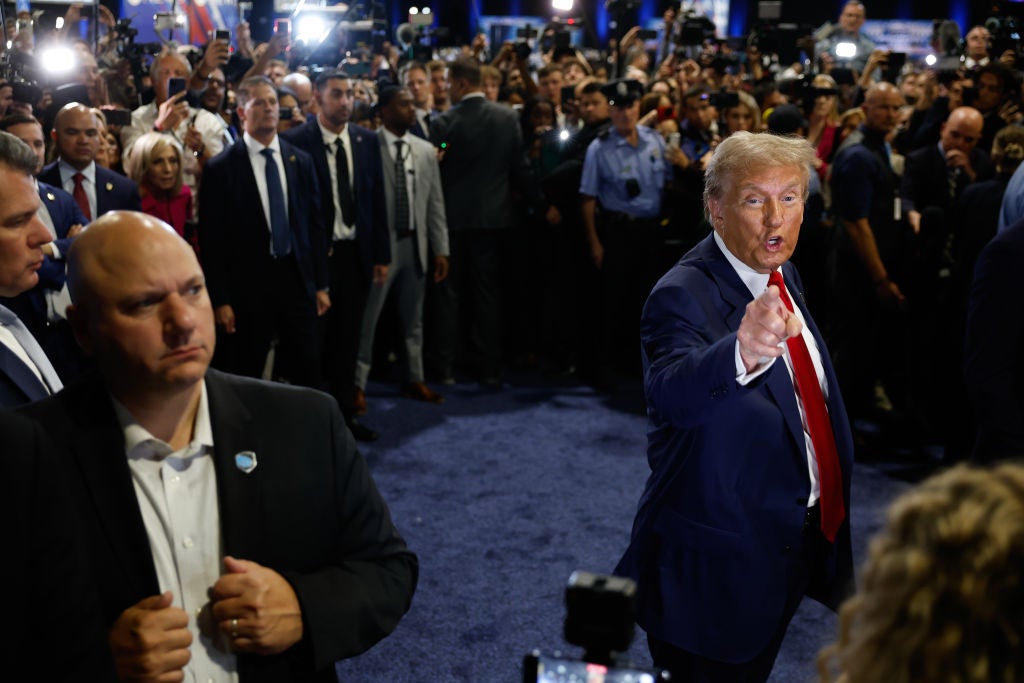 Donald Trump points to Yusef Salaam, a member of the exonerated 'Central Park Five', in the spin room after his debate with Kamala Harris