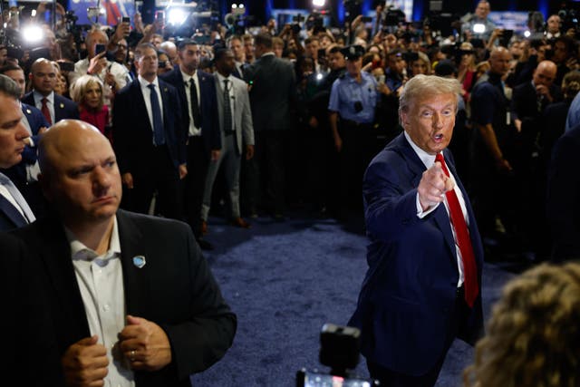 <p>Donald Trump points at Yusef Salaam, a member of the exonerated ‘Central Park Five’, in the spin room after his debate with Kamala Harris</p>