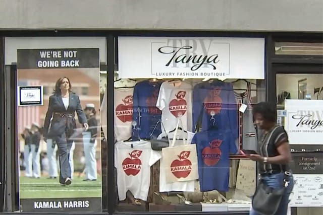 <p>The Vice President Kamala Harris poster and T-shirts in the NYC shop window. An elderly man is being investigated for a hate crime after an altercation with a business owner over the poster </p>