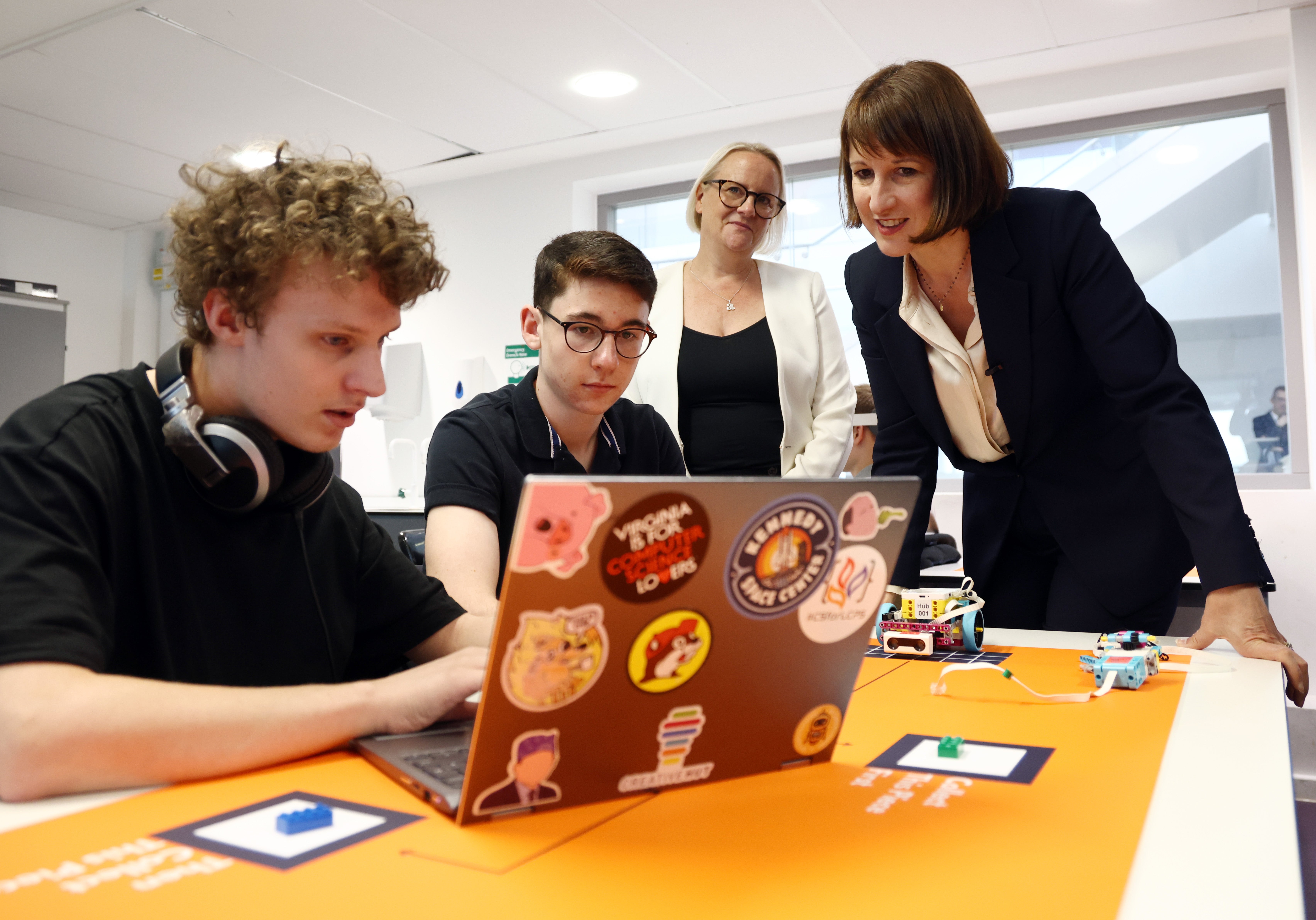 Chancellor of the Exchequer Rachel Reeves (R) speaks to students during a visit to Silverstone University Technical College at Silverstone Circuit