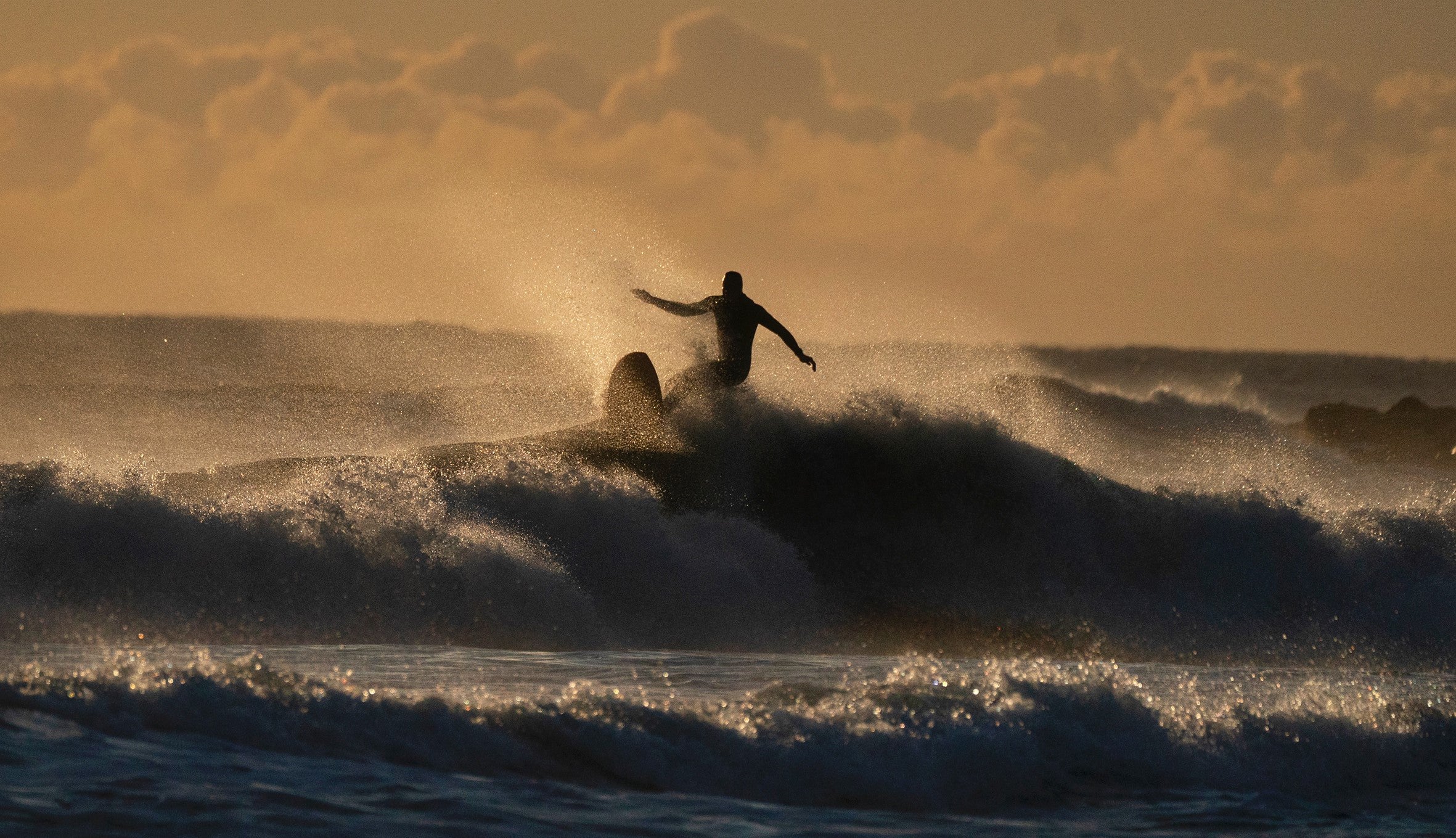 Surfers at Tynemouth Longsands beach on the North East coast (Owen Humphreys/PA)