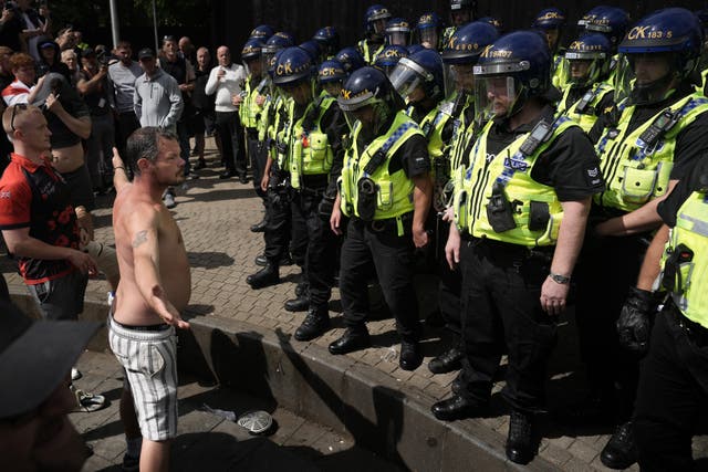 <p>Protesters clash with police in Manchester in August during a summer of riots</p>