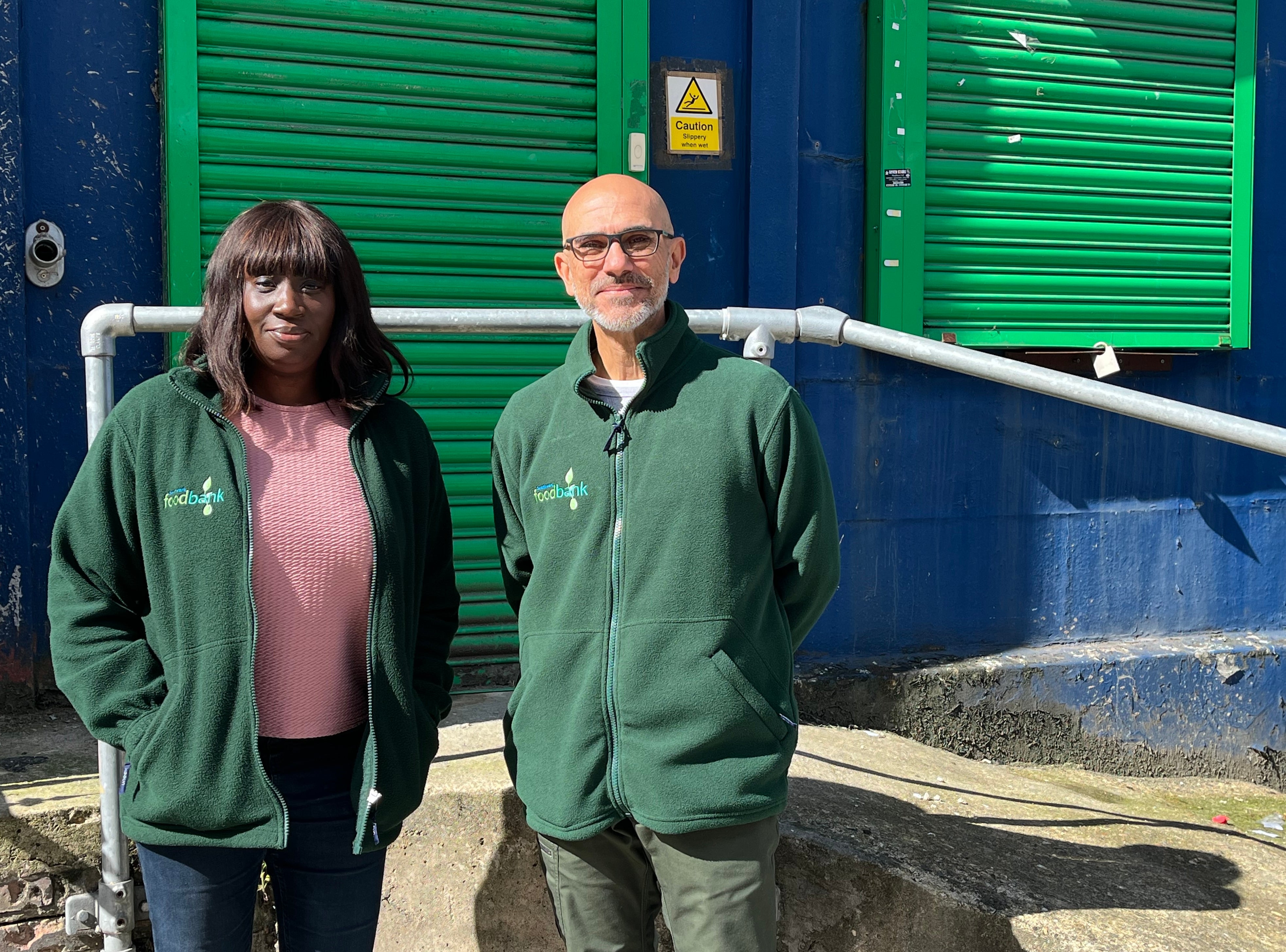 Volunteers Genevieve and Shahid outside the food bank