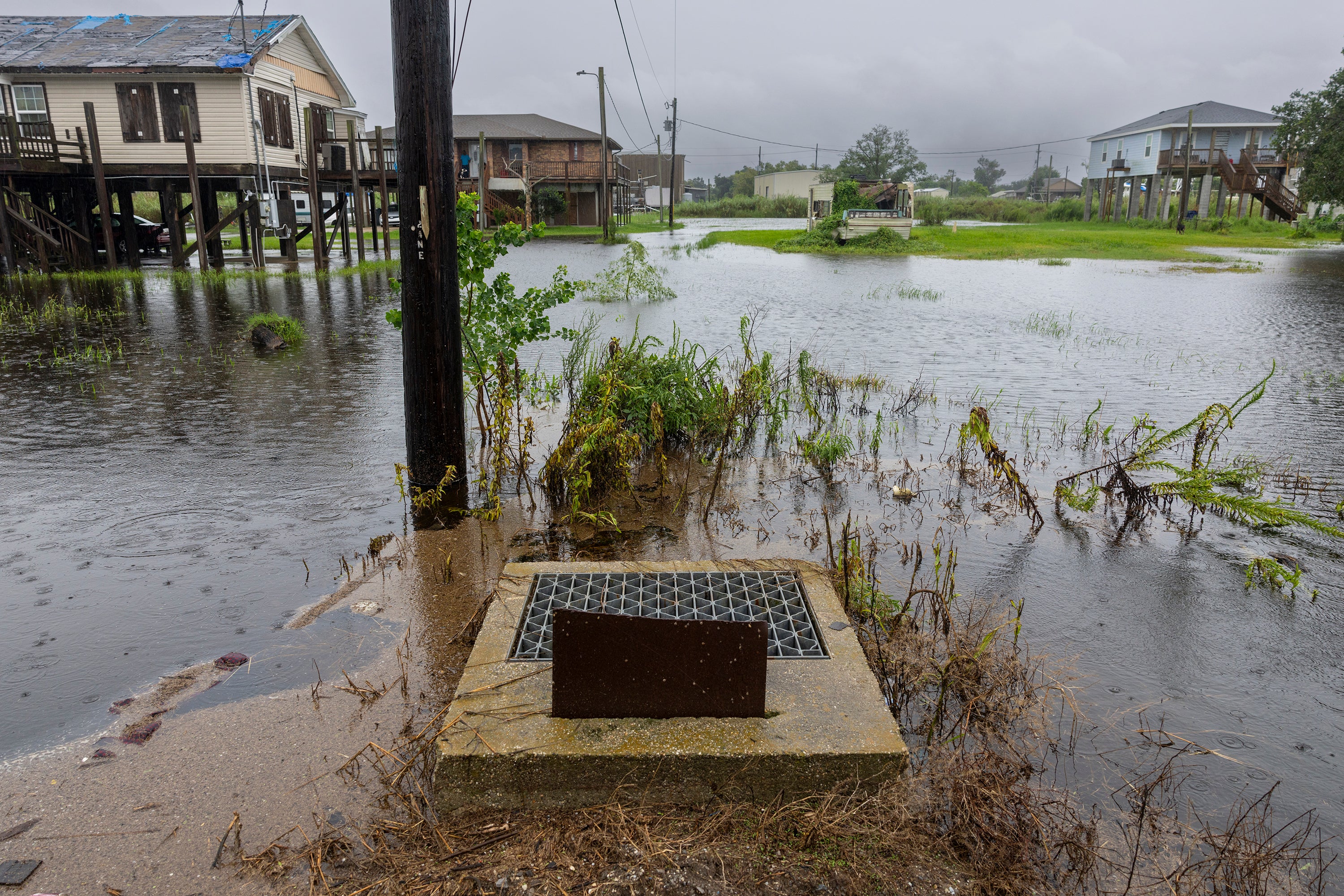 Rising water is seen around a drainage opening in Dulac on Wednesday. The National Hurricane Center said hurricane conditions are expected to begin in southern Louisiana soon.