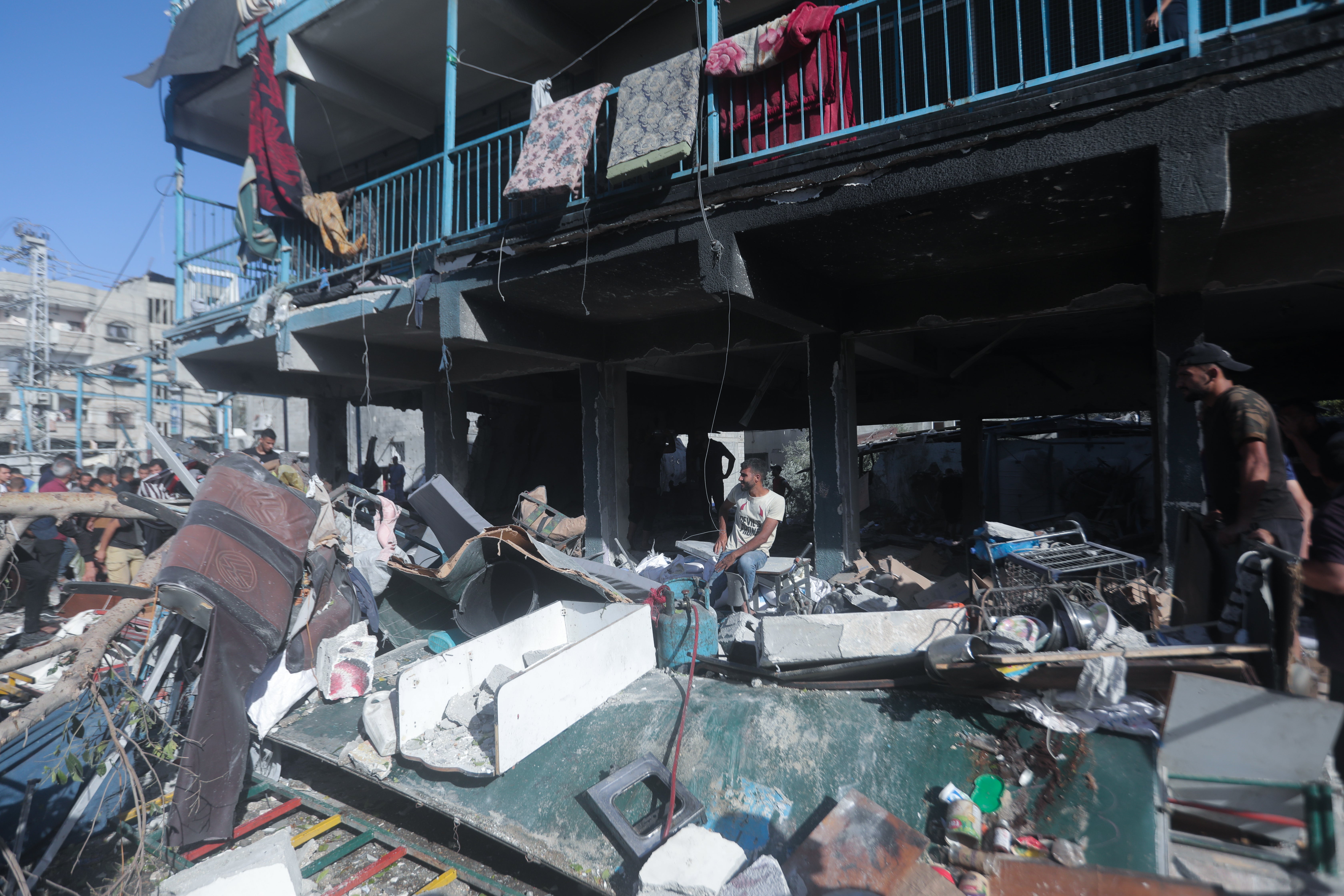 Civil defence teams and civilians search for survivors after an Israeli airstrike on a school in central Gaza