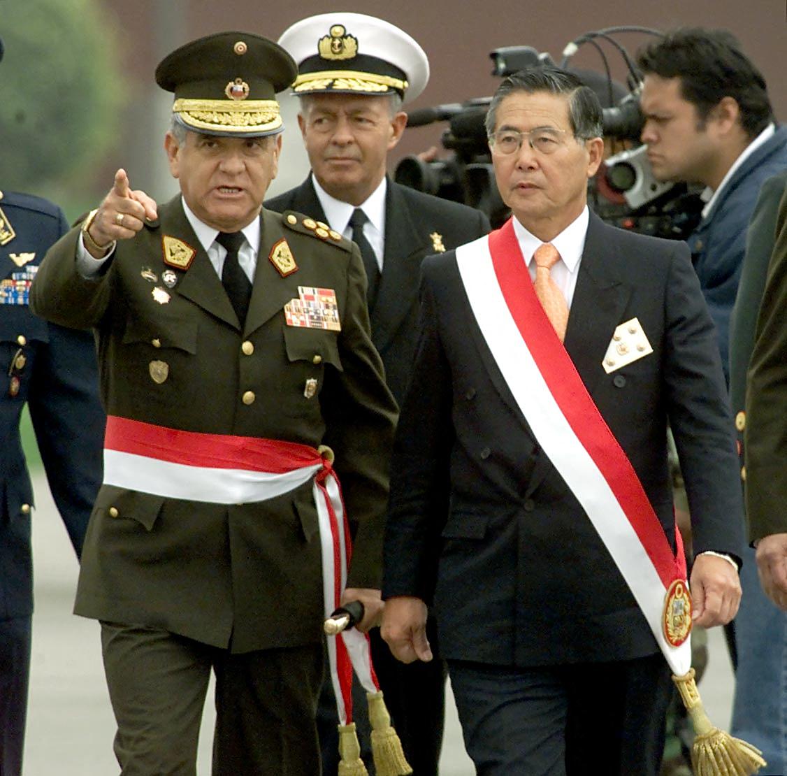 Fujimori reviews the troops with Interior Minister General Cesar Saucedo (L) during a military parade 29 July, 2000, in Lima