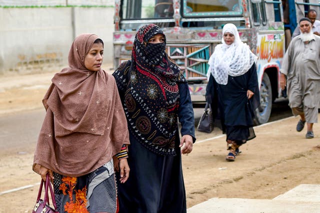 <p>File image shows women arriving for work at a leather factory in Karachi, Pakistan. SheDrives, Pakistan’s new ride-share service, will only allow trans people and women to use it </p>