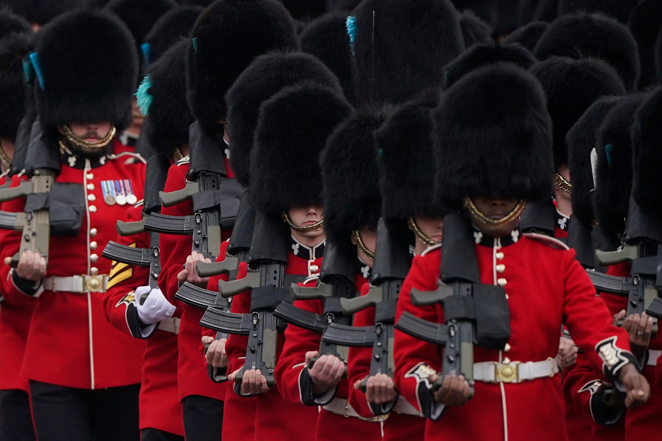 Soldiers from the Irish Guards march along the Mall as they take part in the Trooping the Color ceremony