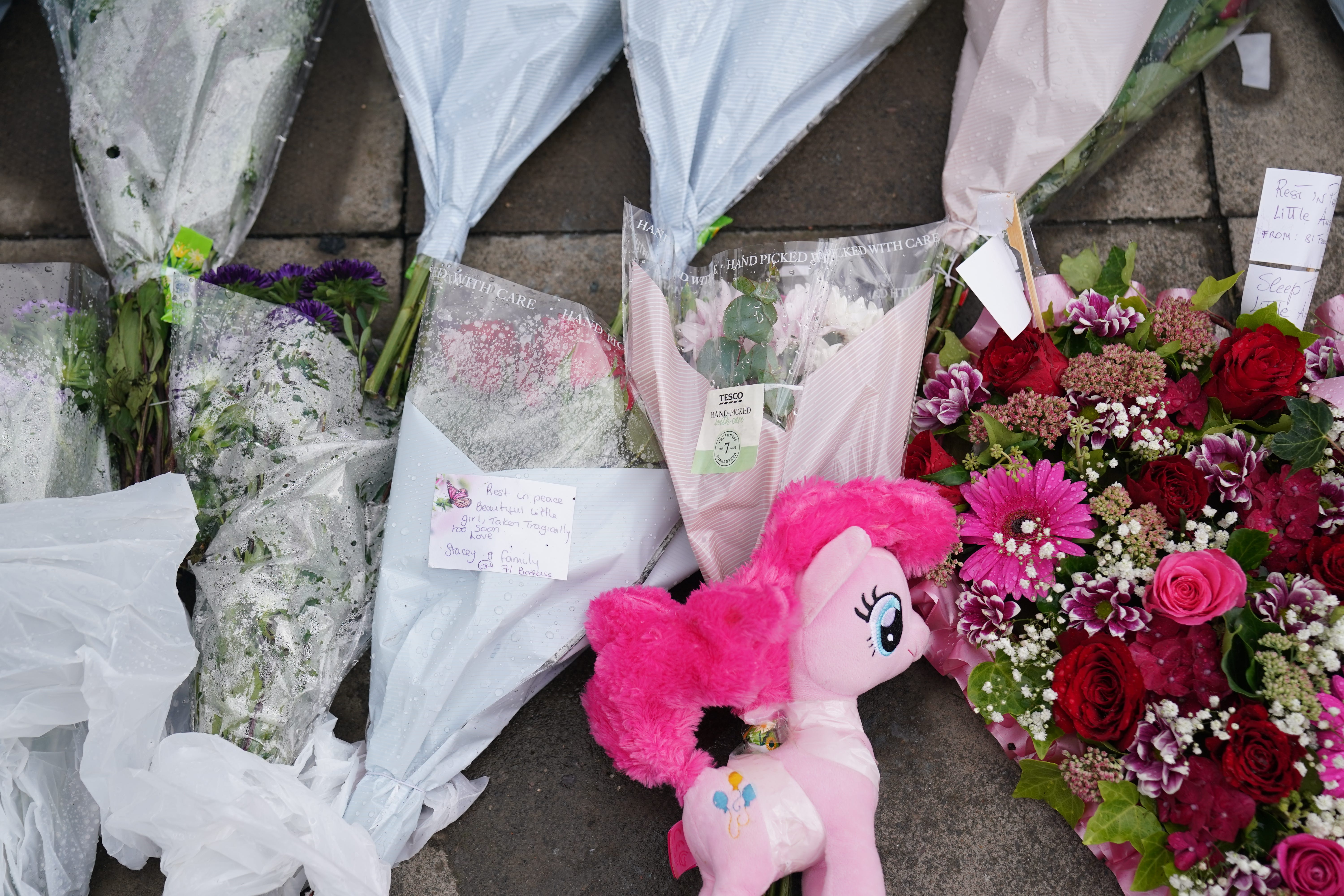 Flowers and tributes left outside the house (Jacob King/PA)