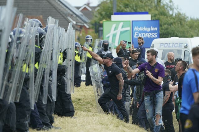 <p>Policing this summer’s unrest cost £31.7m, chiefs have revealed. Pictured, officers clashing with rioters outside the Holiday Inn Express in Rotherham </p>