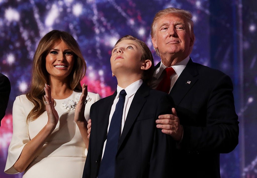 Donald Trump embraces his son Barron as his wife Melania Trump looks on at the end of the Republican National Convention on 12 July 2016