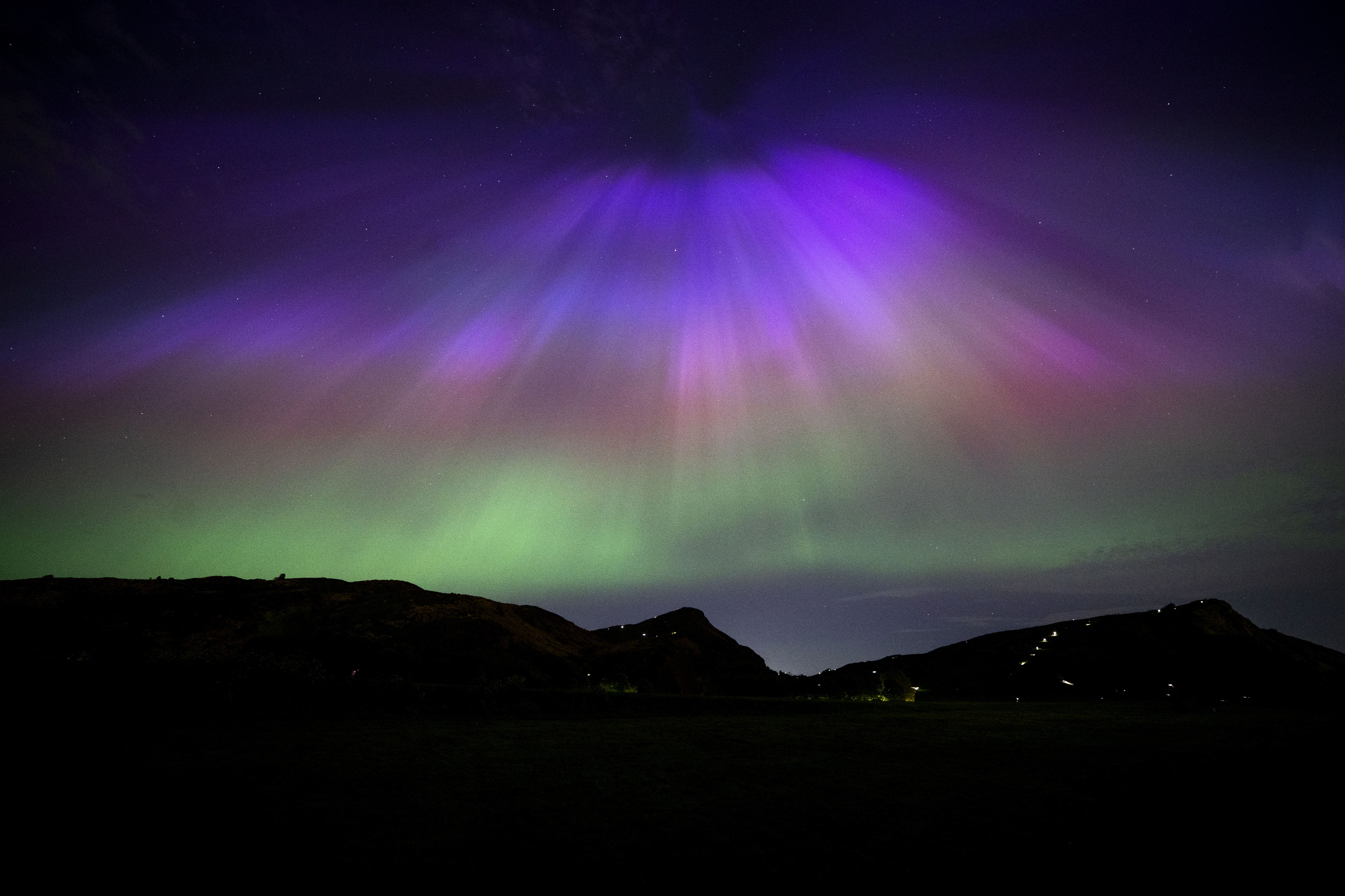 The aurora borealis above Arthur’s Seat and Salisbury Crags in Holyrood Park, Edinburgh in May (Jane Barlow/PA)