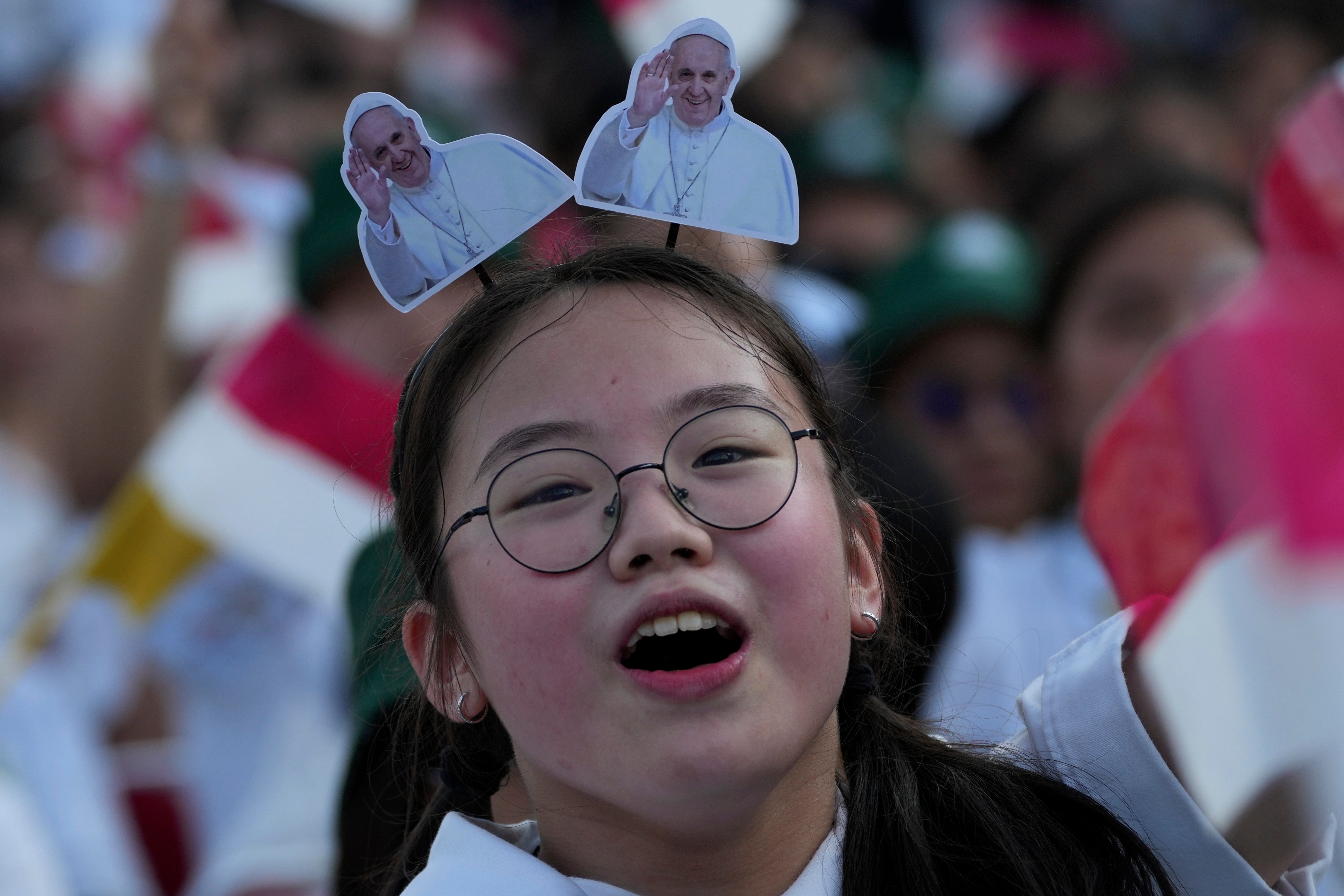 A girl reacts as Pope Francis arrives at Madya Stadium in Jakarta, Indonesia