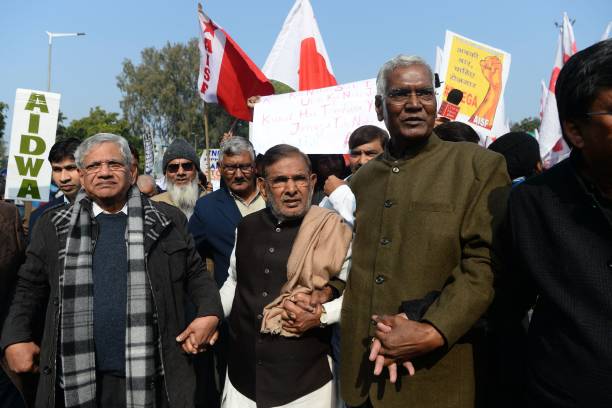 Sitaram Yechury, left, takes part in a demonstration against an attack on students and teachers at a university in Delhi on 9 January 2020