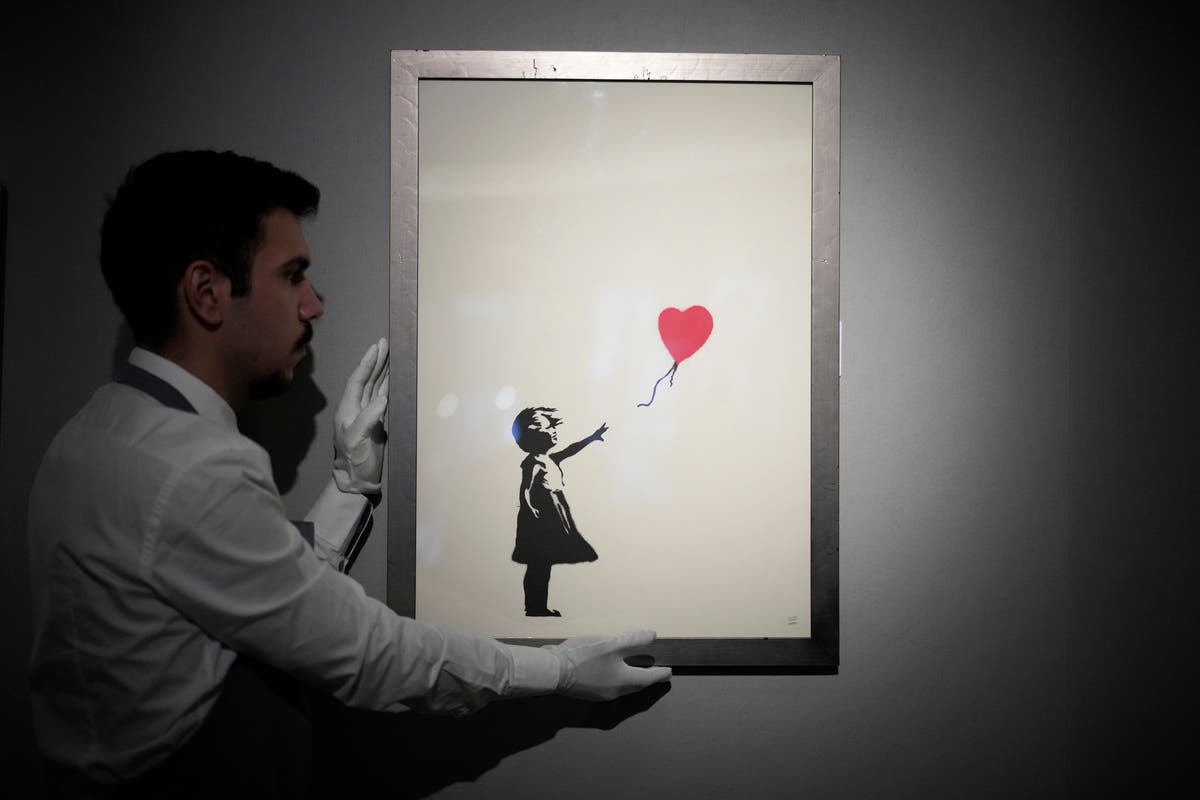 2 men charged with stealing a famous Banksy image from a London art gallery