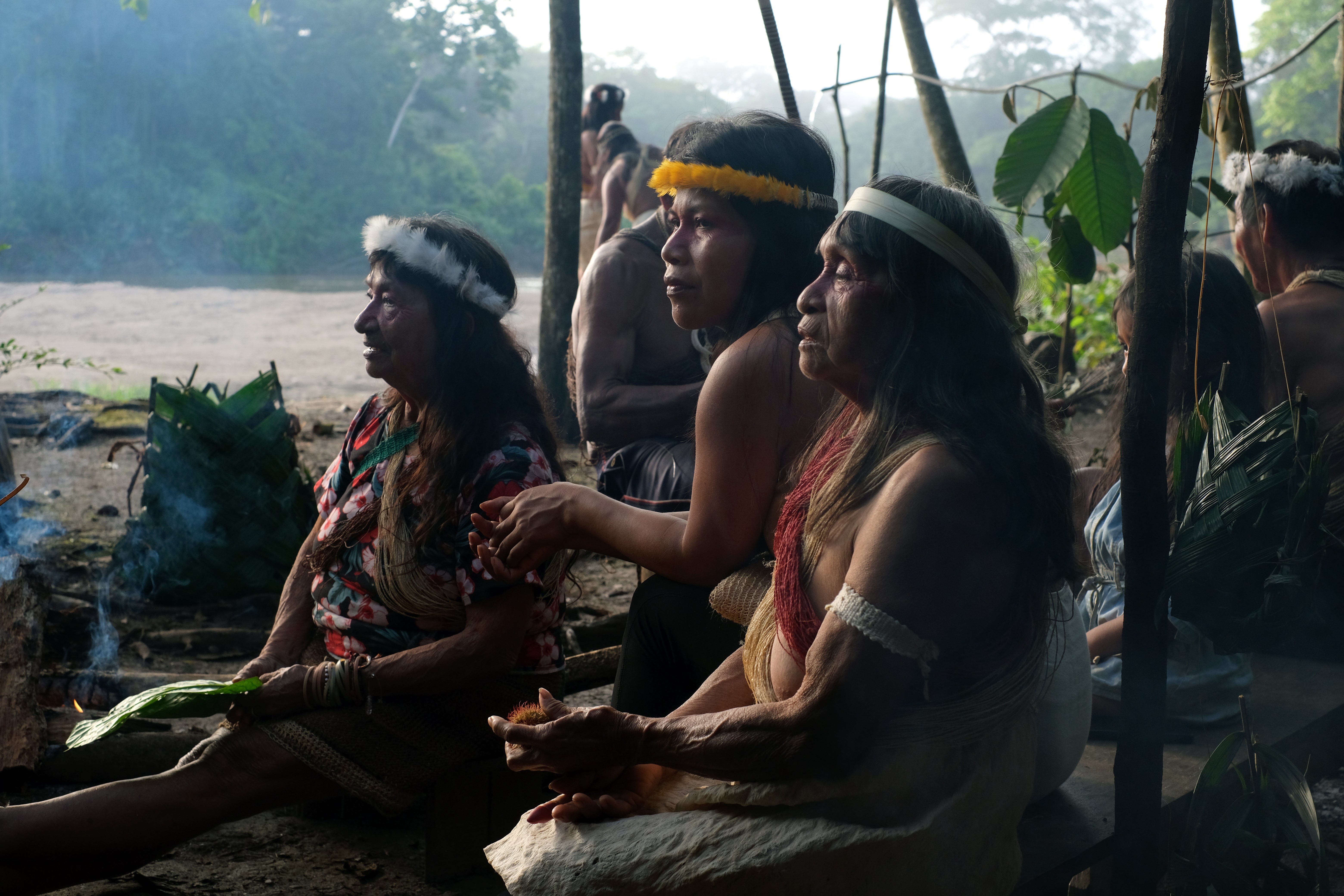 Waorani leader Nemonte Nenquimo alongside elders Okeñene and Wina Omaca during a community gathering