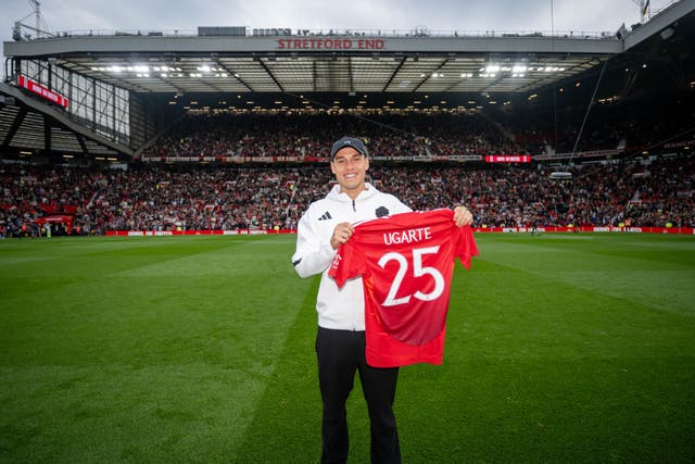 <p>Manuel Ugarte poses in front of the Stretford End</p>