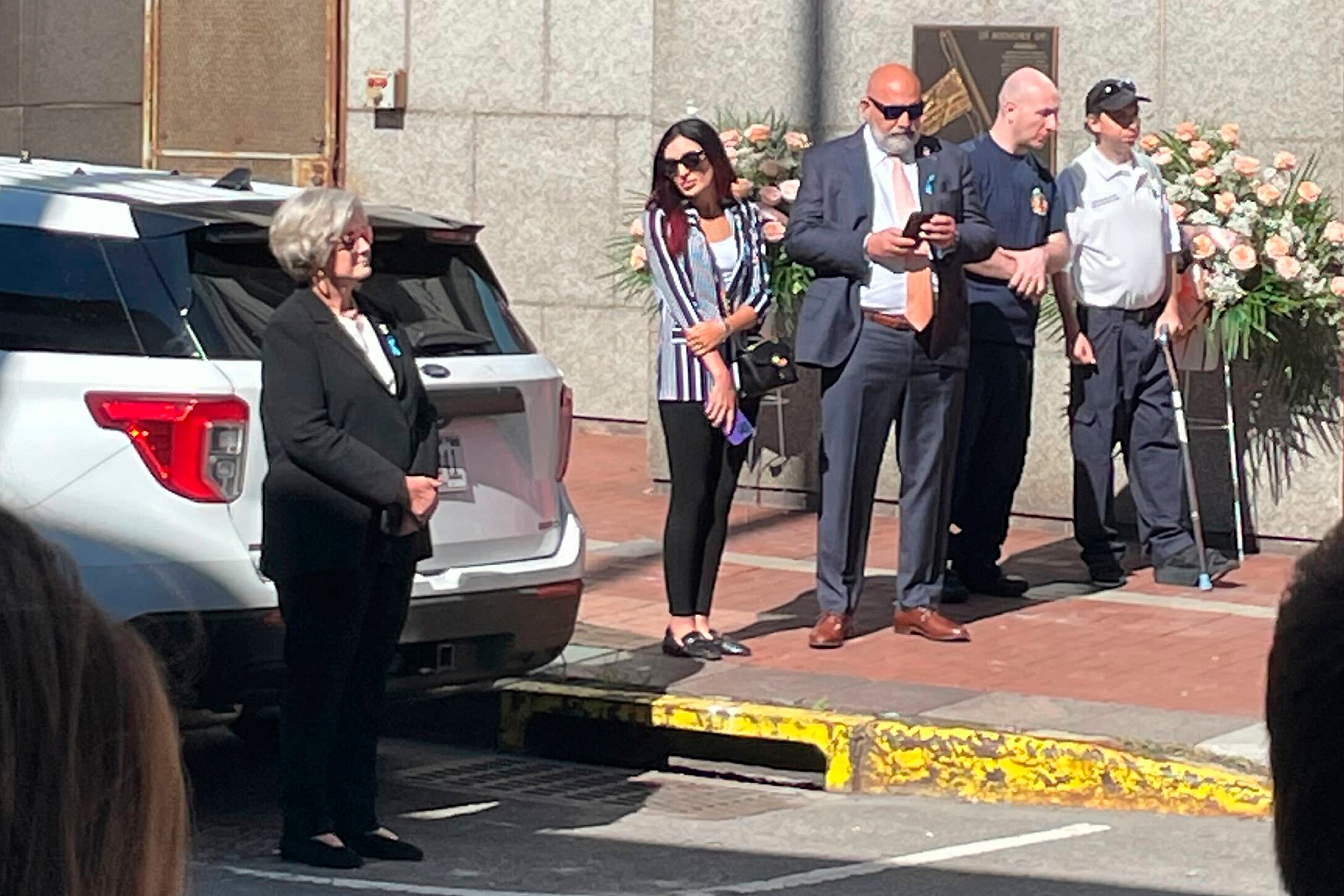 Loomer (center) outside Engine 4 Ladder 15, during a visit by Donald Trump on the 23rd anniversary of the September 11 attacks