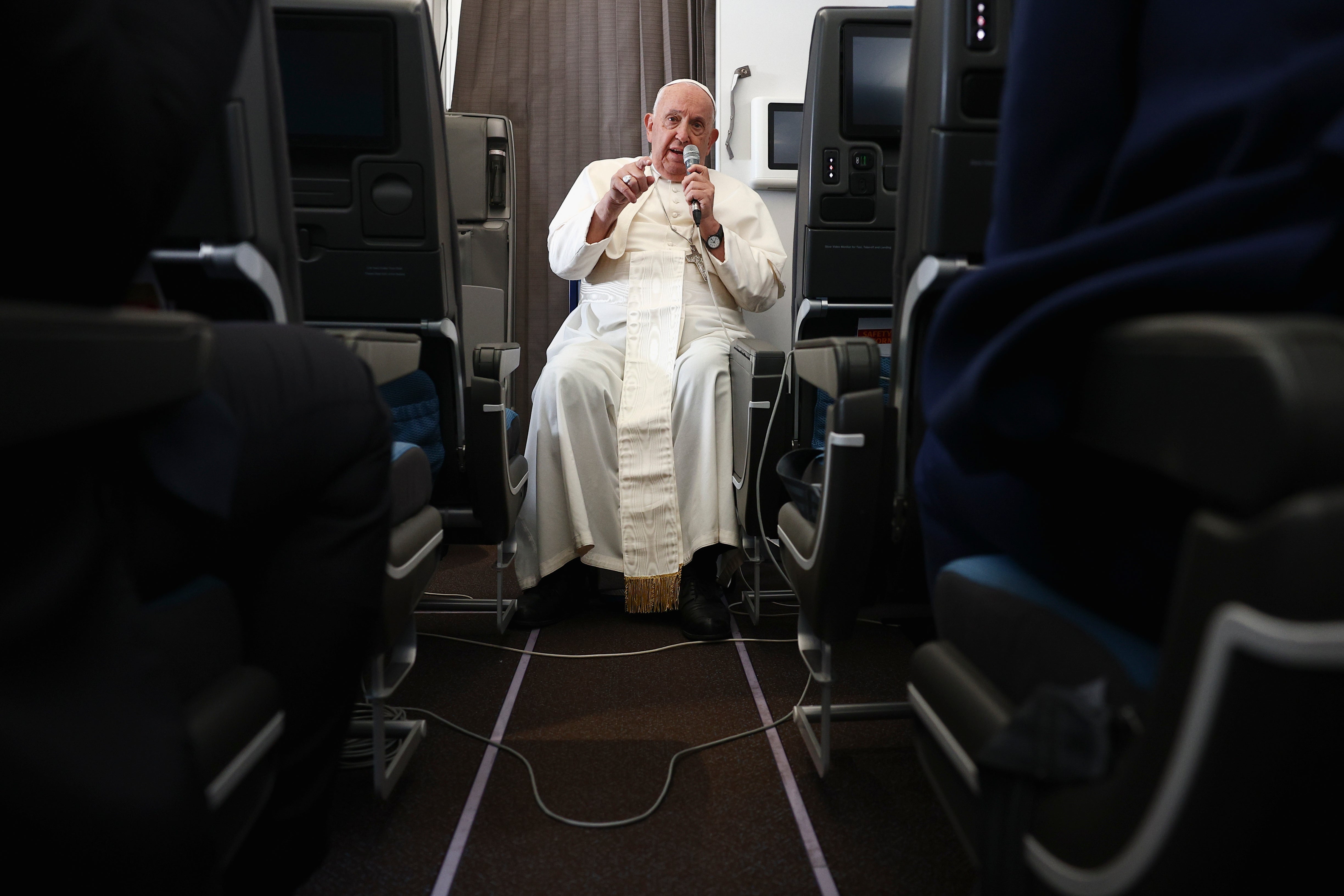 Pope Francis holds a news conference aboard the papal plane on his flight back after his 12-day journey across southeast Asia and Oceania