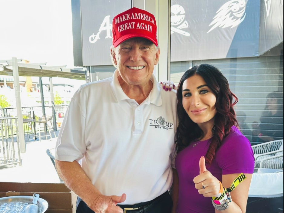 Donald Trump and Laura Loomer pose at an LIV golf event in August 2023