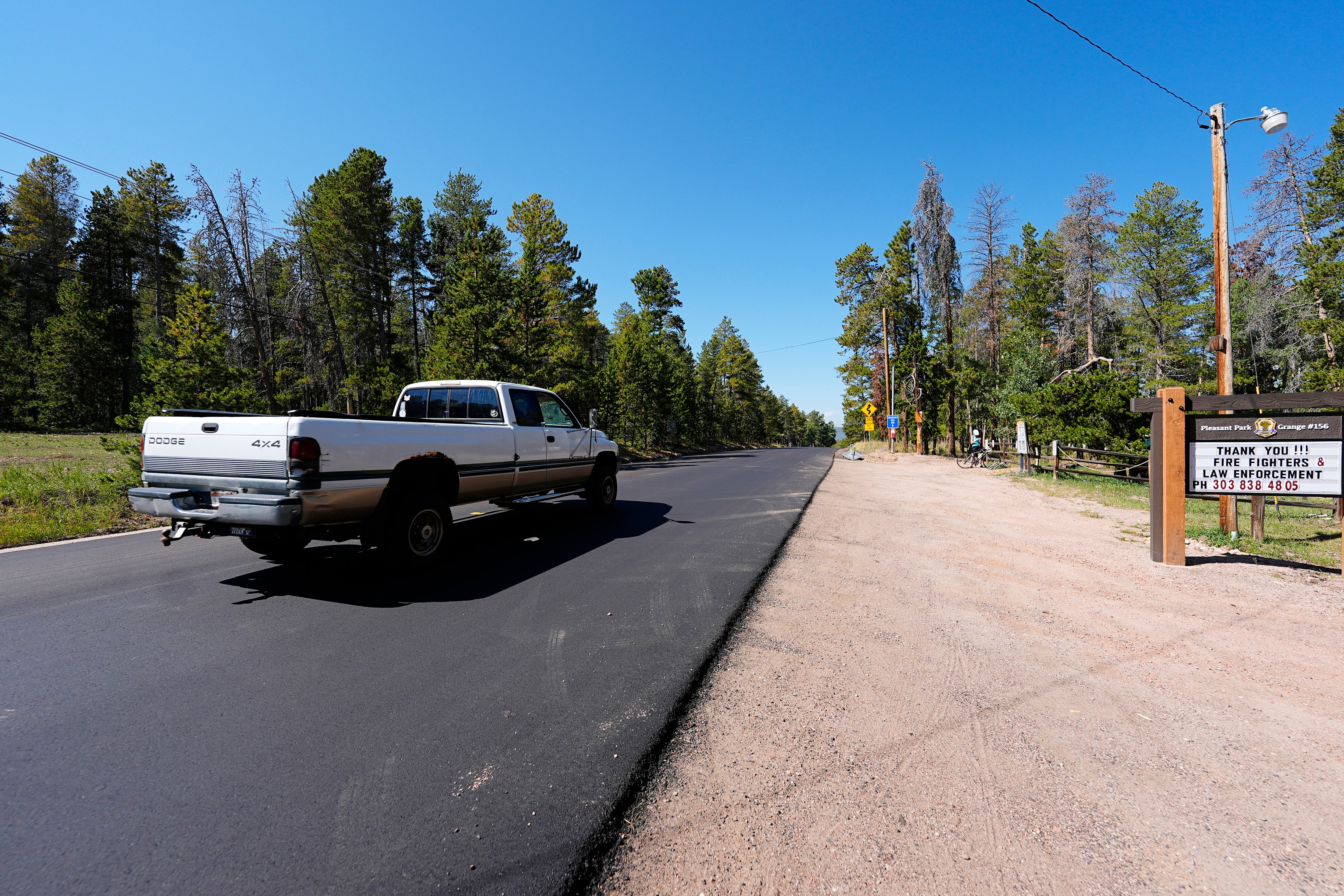 A pickup truck moves along the 23000 block of Pleasant Park Road where a teenager, who was scouting for a location for lakeside homecoming photos, was shot in the face by a town councilman earlier this week