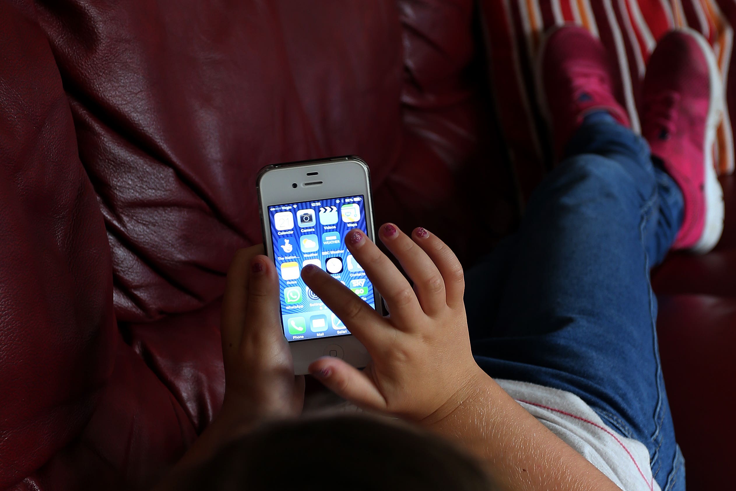 File photo of a child using an Apple iPhone (PA)