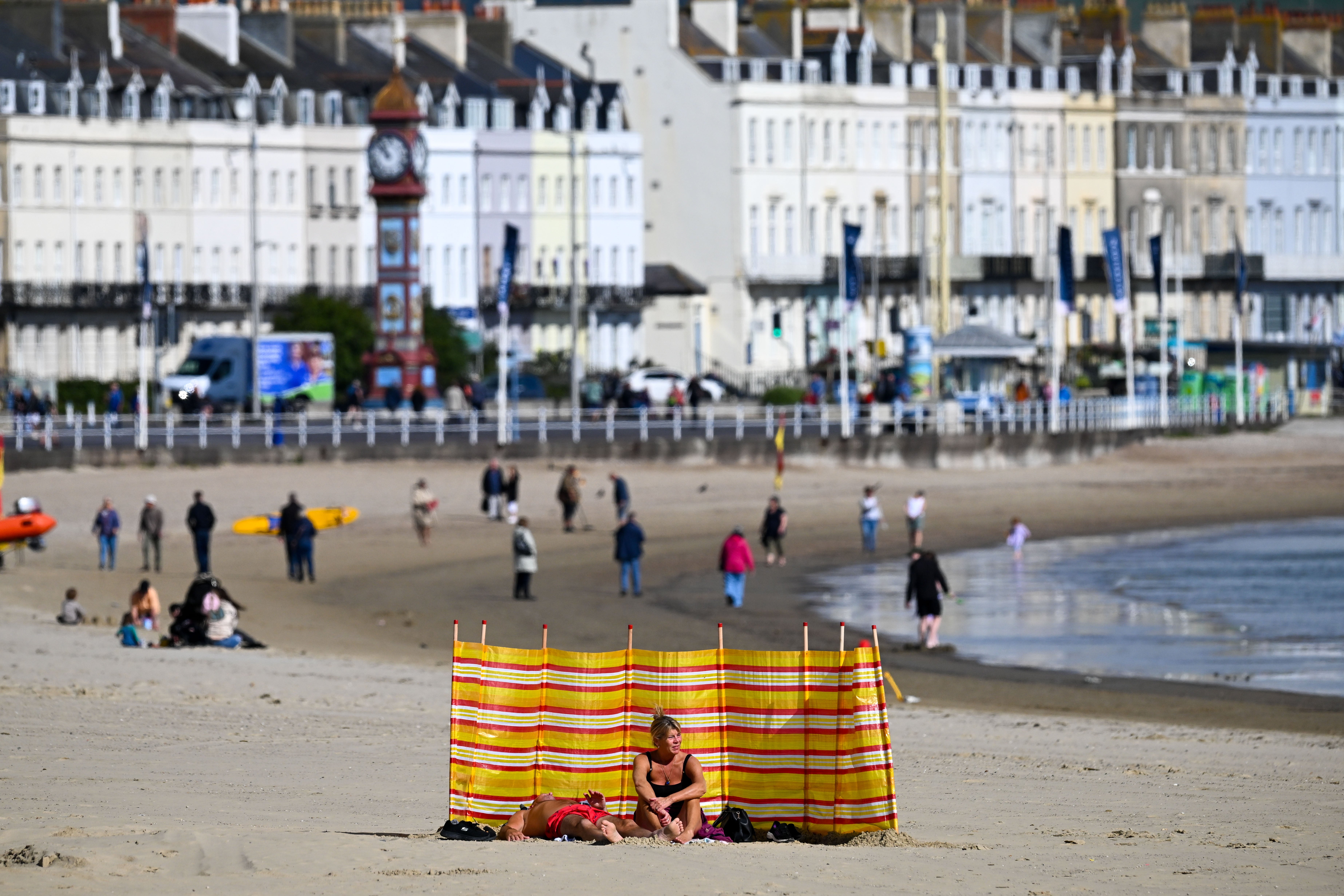 People enjoy the sunshine on Weymouth beach as the summer season nears its end